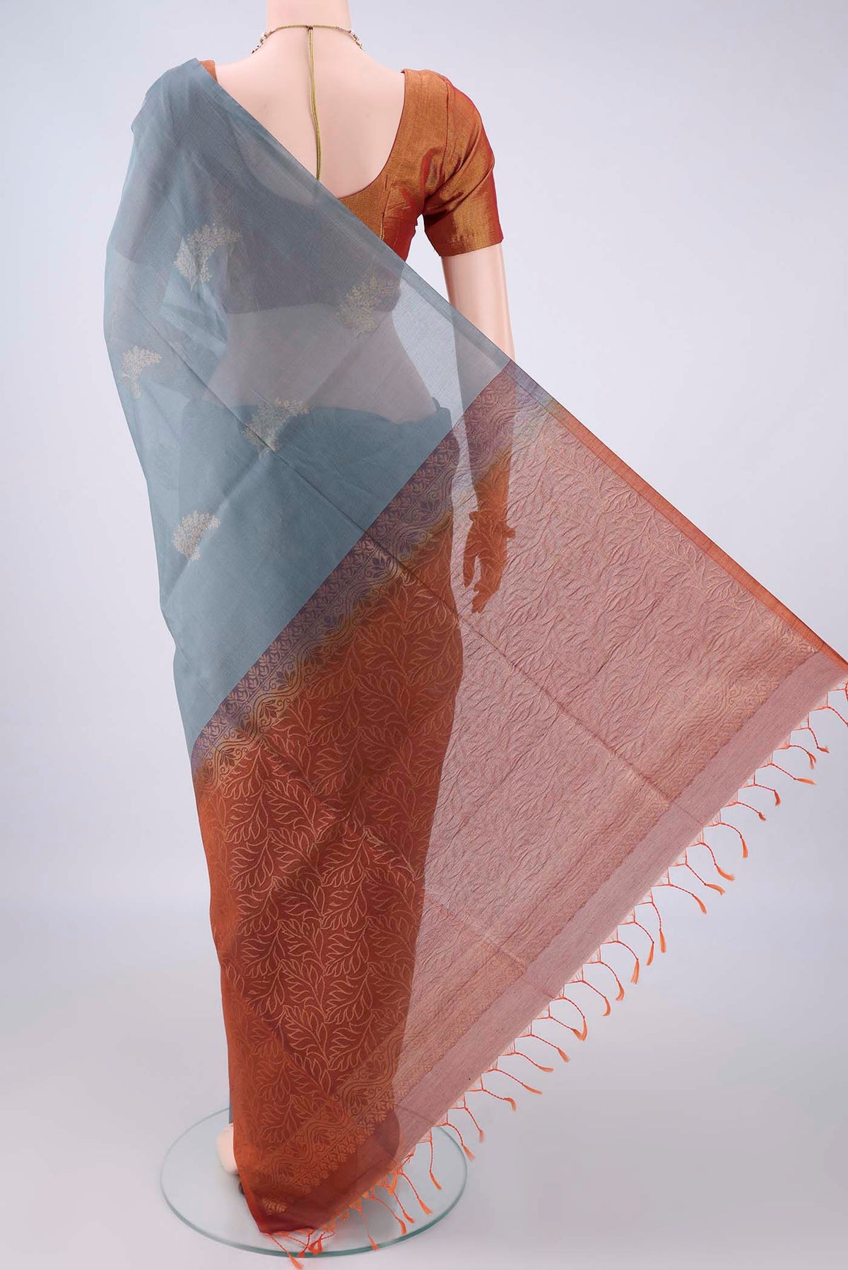 Flat view of Grey Silk Cotton Saree with Zari Butta on the body and Without Border. 