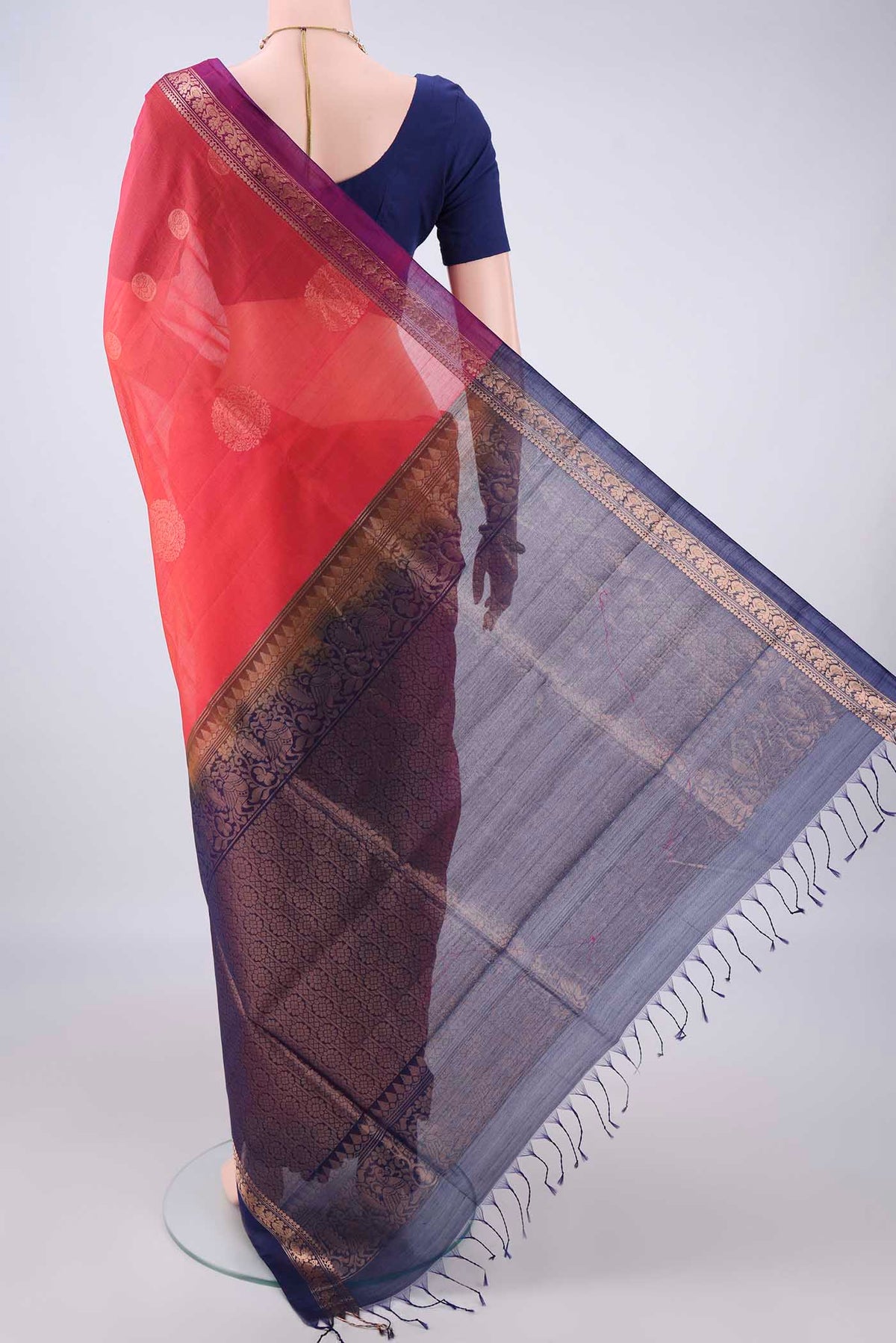 Flat view of Coral Silk Cotton Saree with Zari Butta on the body and Zari Border. 