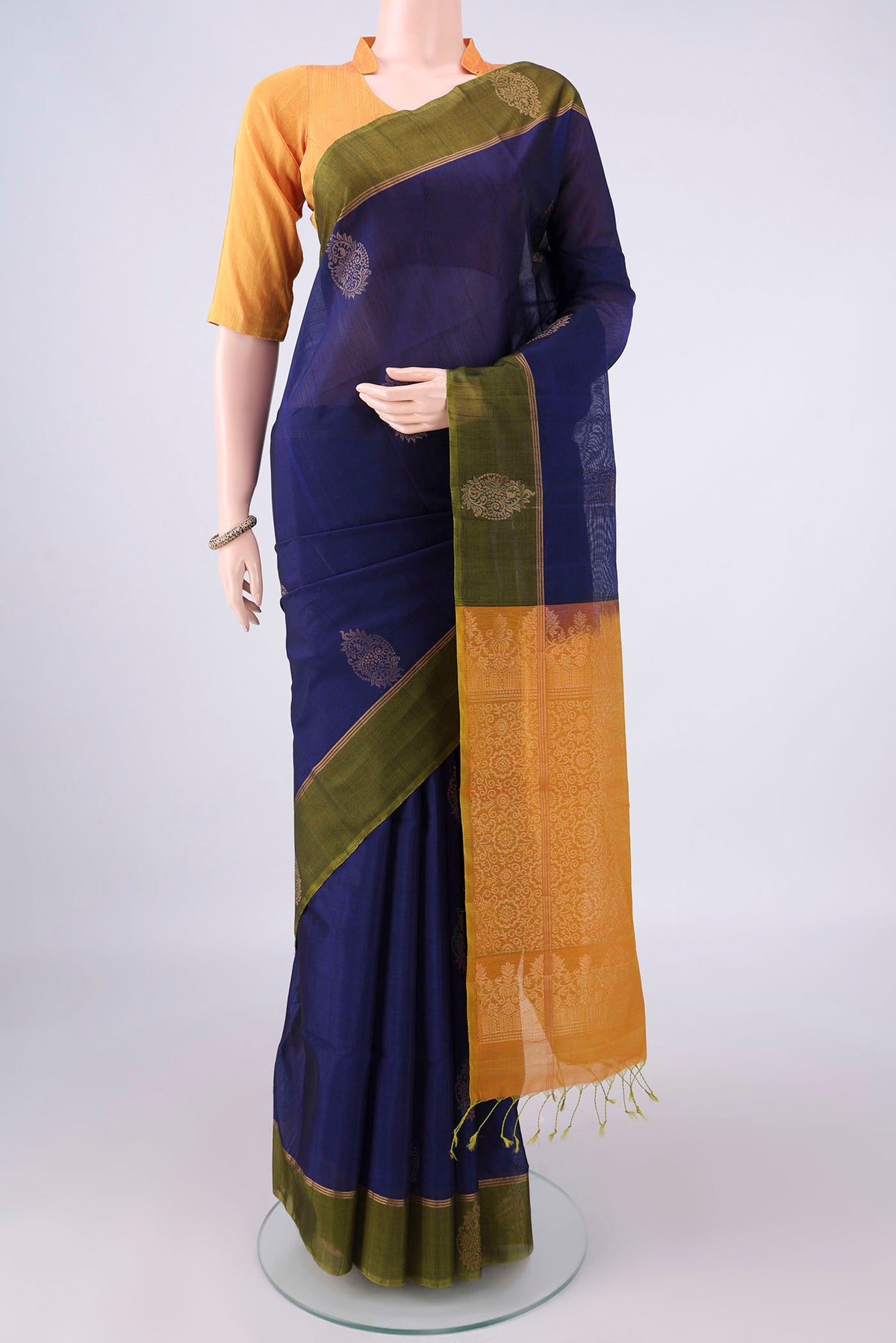 Navy Blue Silk Cotton Saree with Zari Butta on the body and Zari Border.  displayed on a mannequin