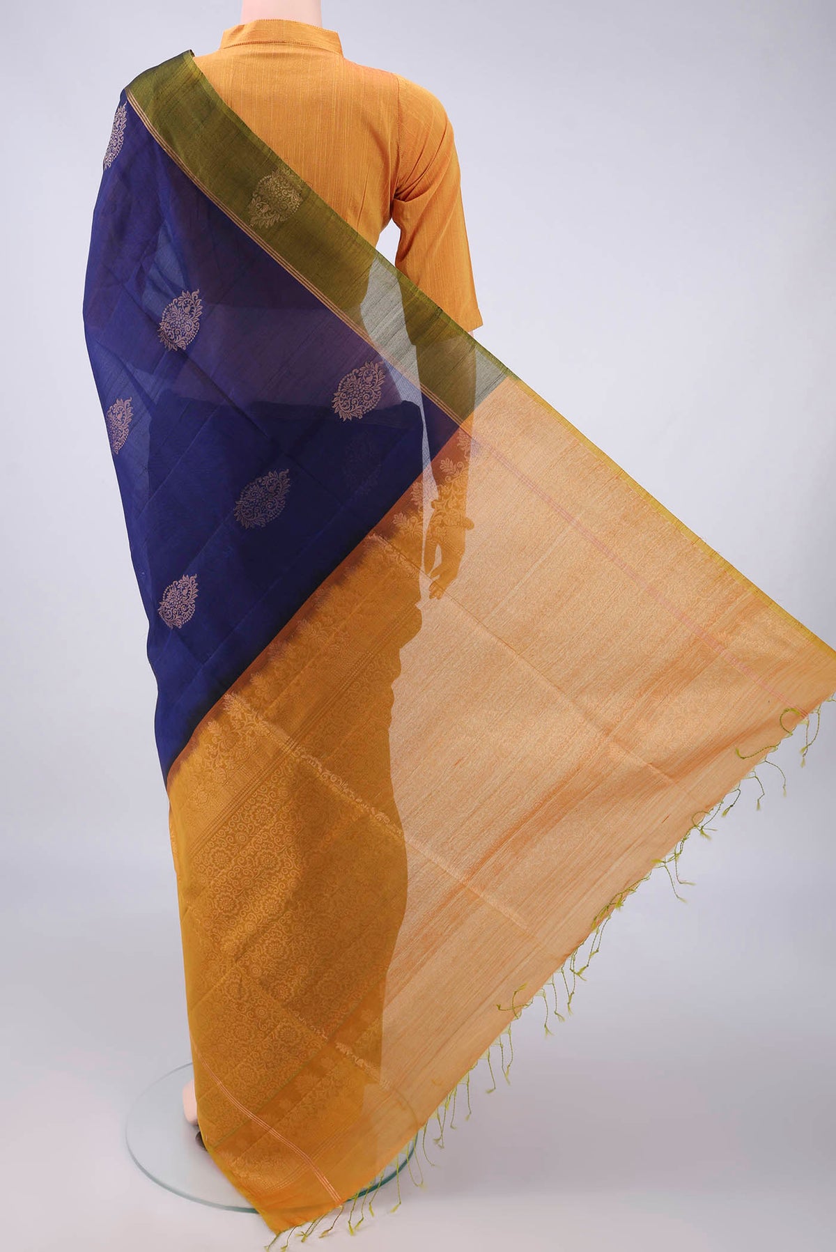 Flat view of Navy Blue Silk Cotton Saree with Zari Butta on the body and Zari Border. 