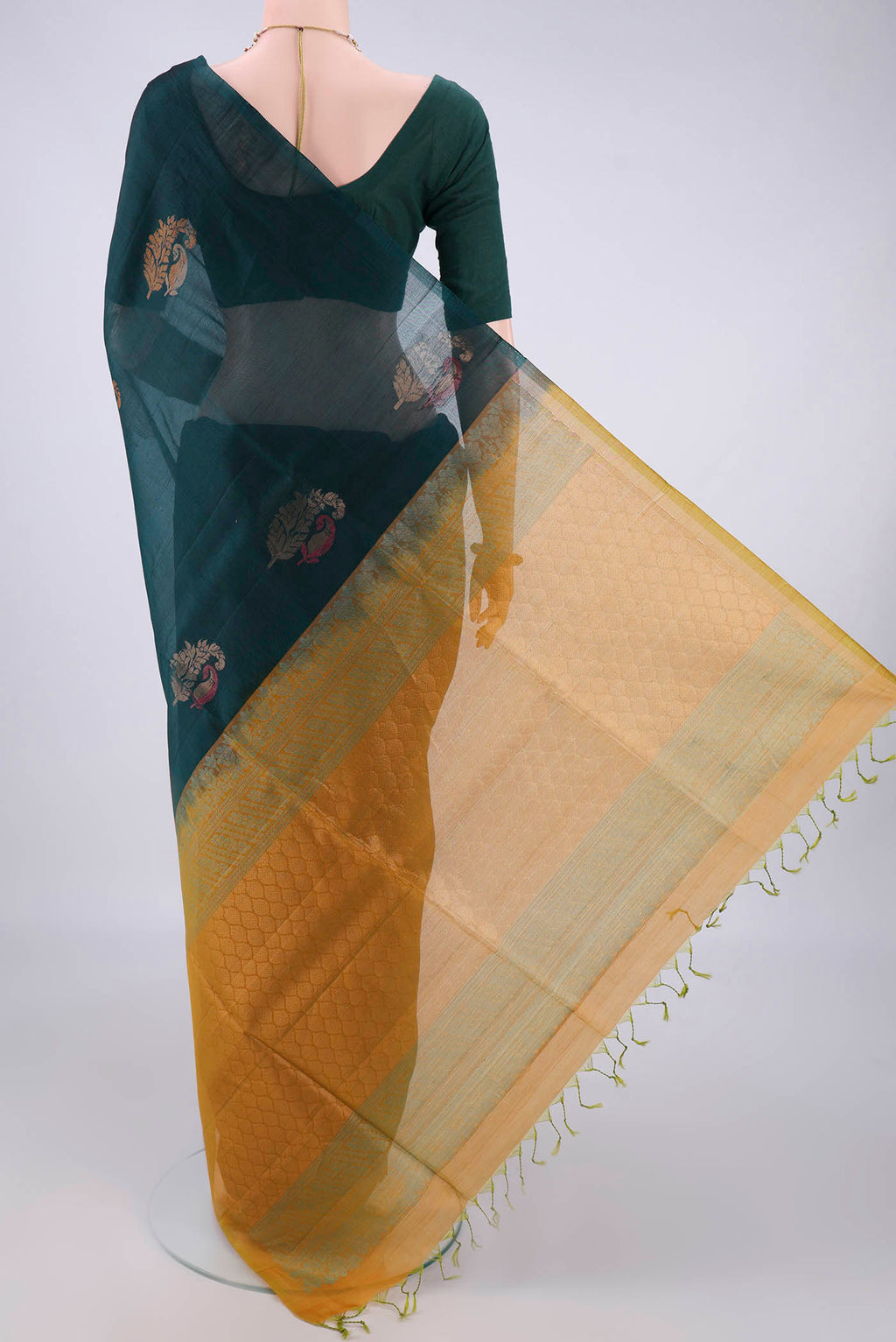 Flat view of Bottle Green Silk Cotton Saree with Zari And Thread Butta on the body and Without Border. 