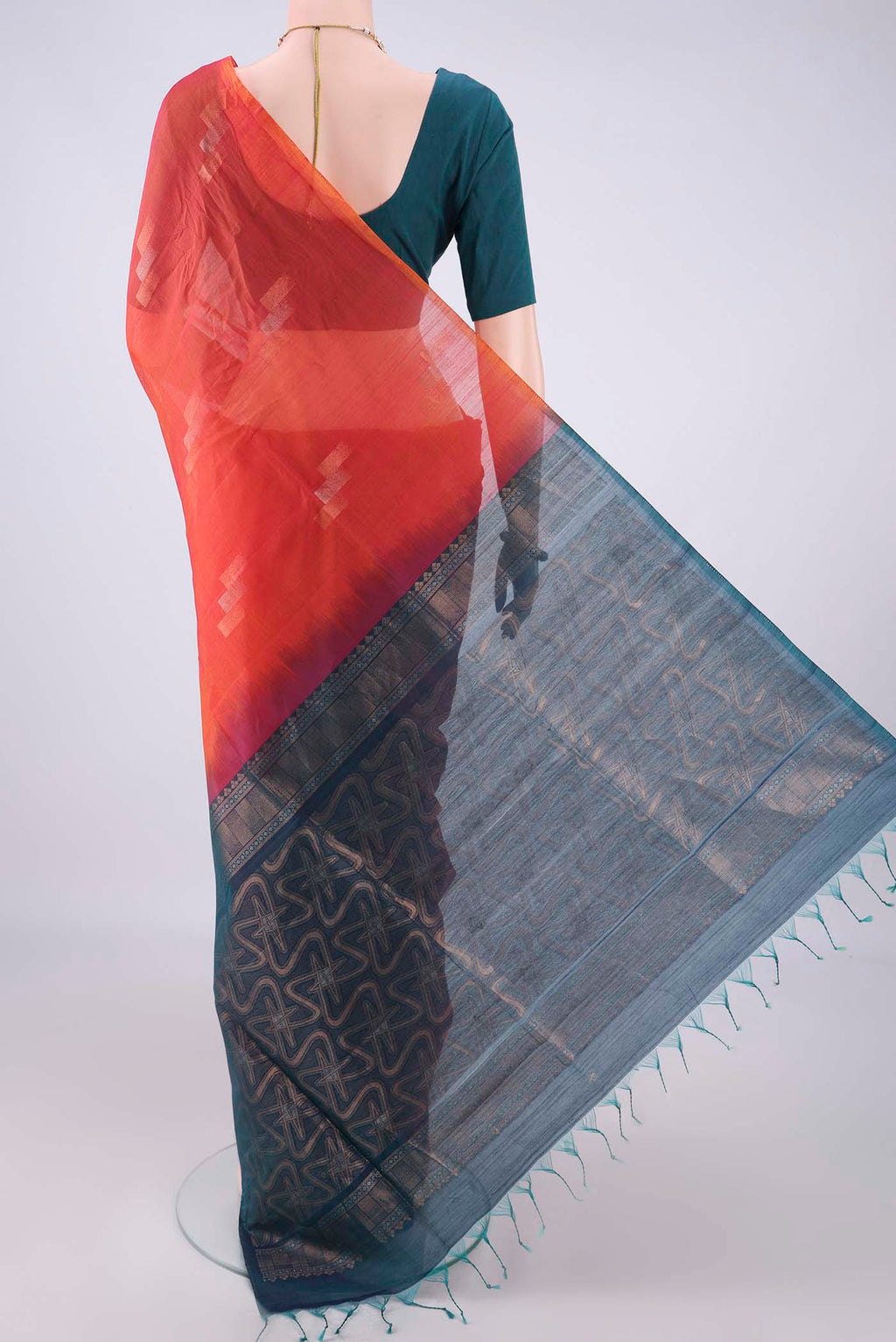 Flat view of Brick Orange Silk Cotton Saree with Zari Butta on the body and Without Border. 