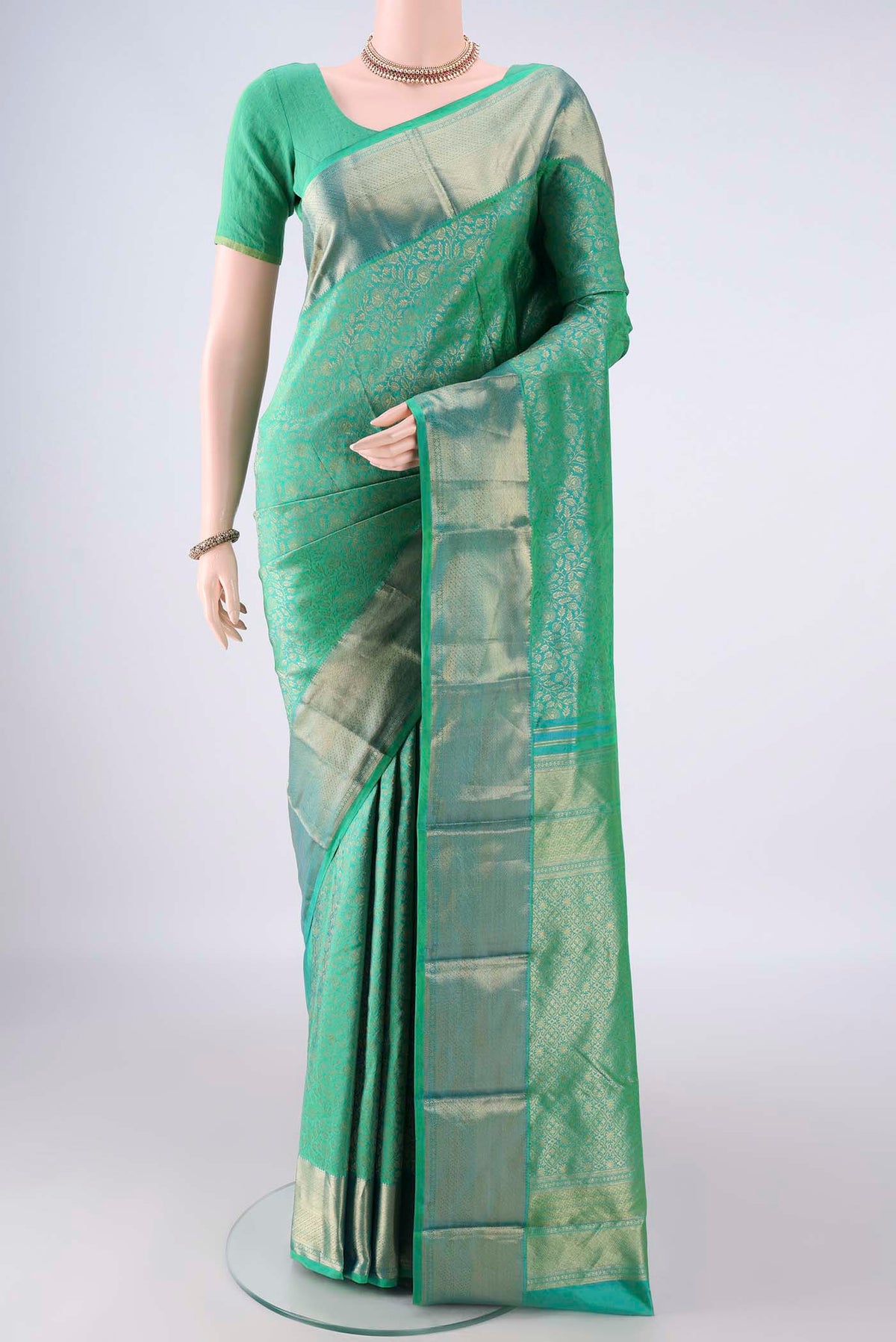 Pure Silk Sea Green Kanjivaram Saree with Zari Brocade on the body and Zari Border.  displayed on a mannequin