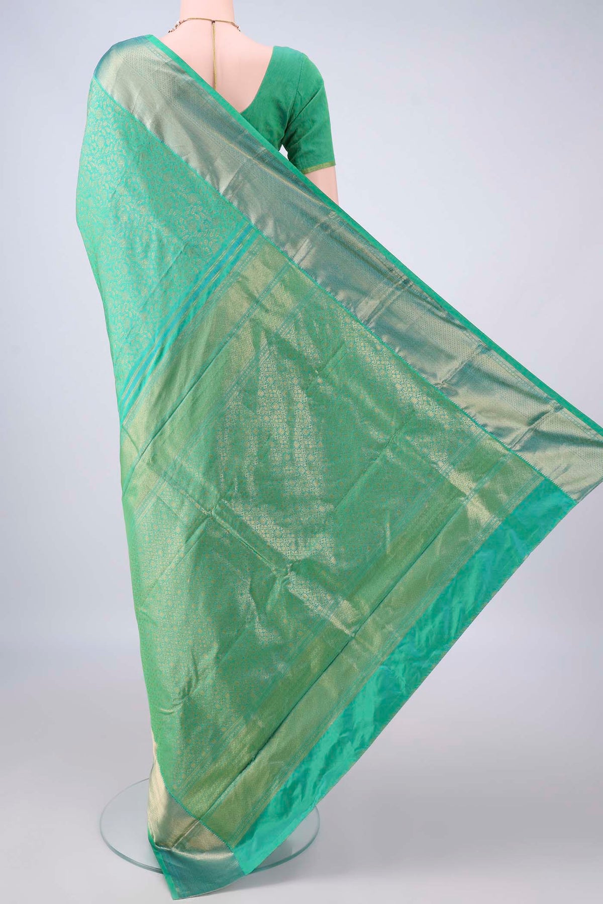 Flat view of Pure Silk Sea Green Kanjivaram Saree with Zari Brocade on the body and Zari Border. 