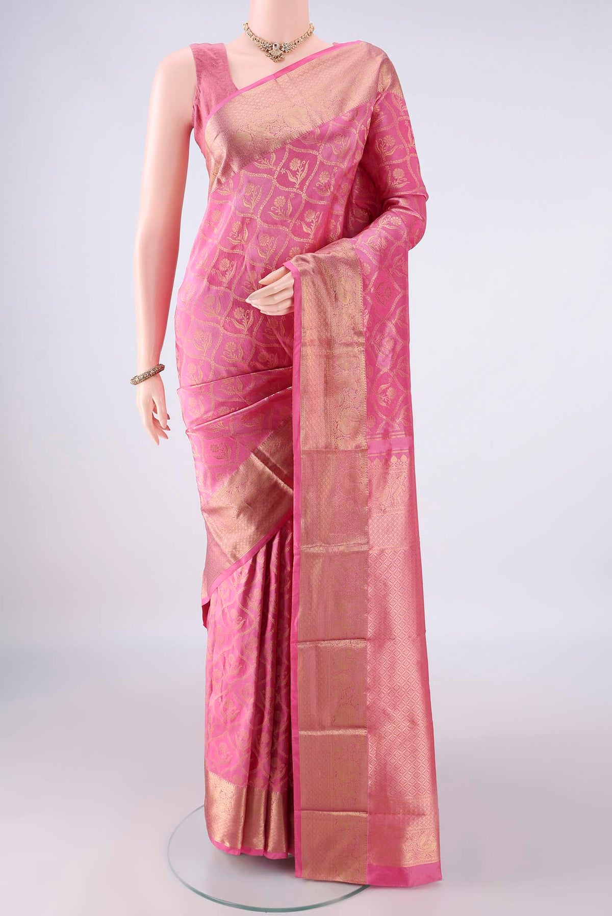 Pure Silk Rose pink Kanjivaram Saree with Zari Brocade on the body and Zari Border.  displayed on a mannequin