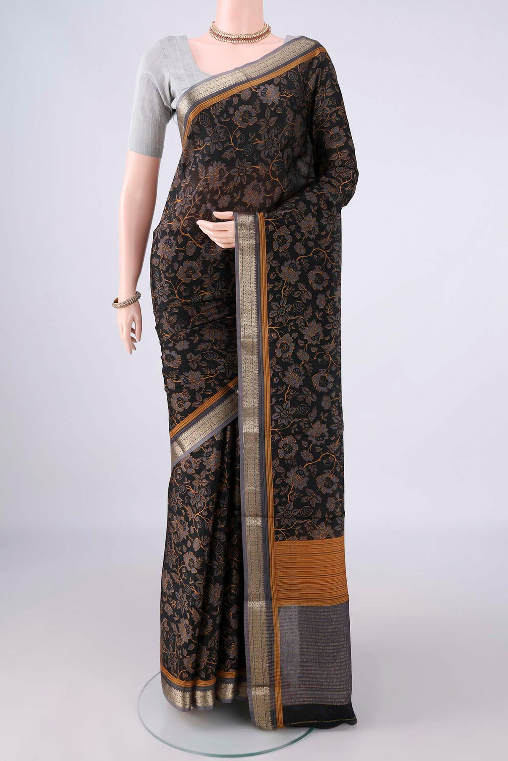 Black Mysore Crepe Saree with Printed design on the body and Zari Border.  displayed on a mannequin