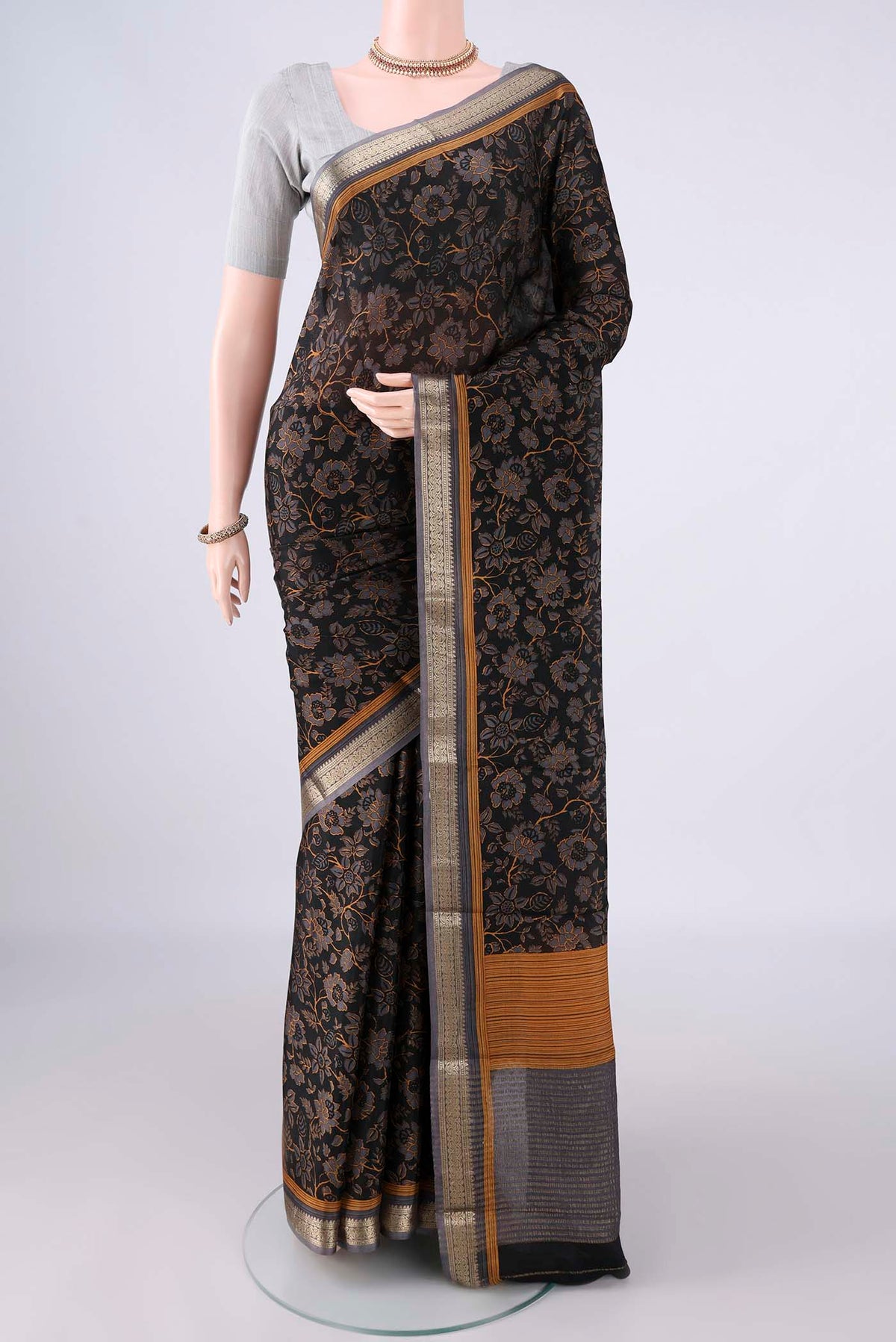 Black Mysore Crepe Saree with Printed design on the body and Zari Border.  displayed on a mannequin