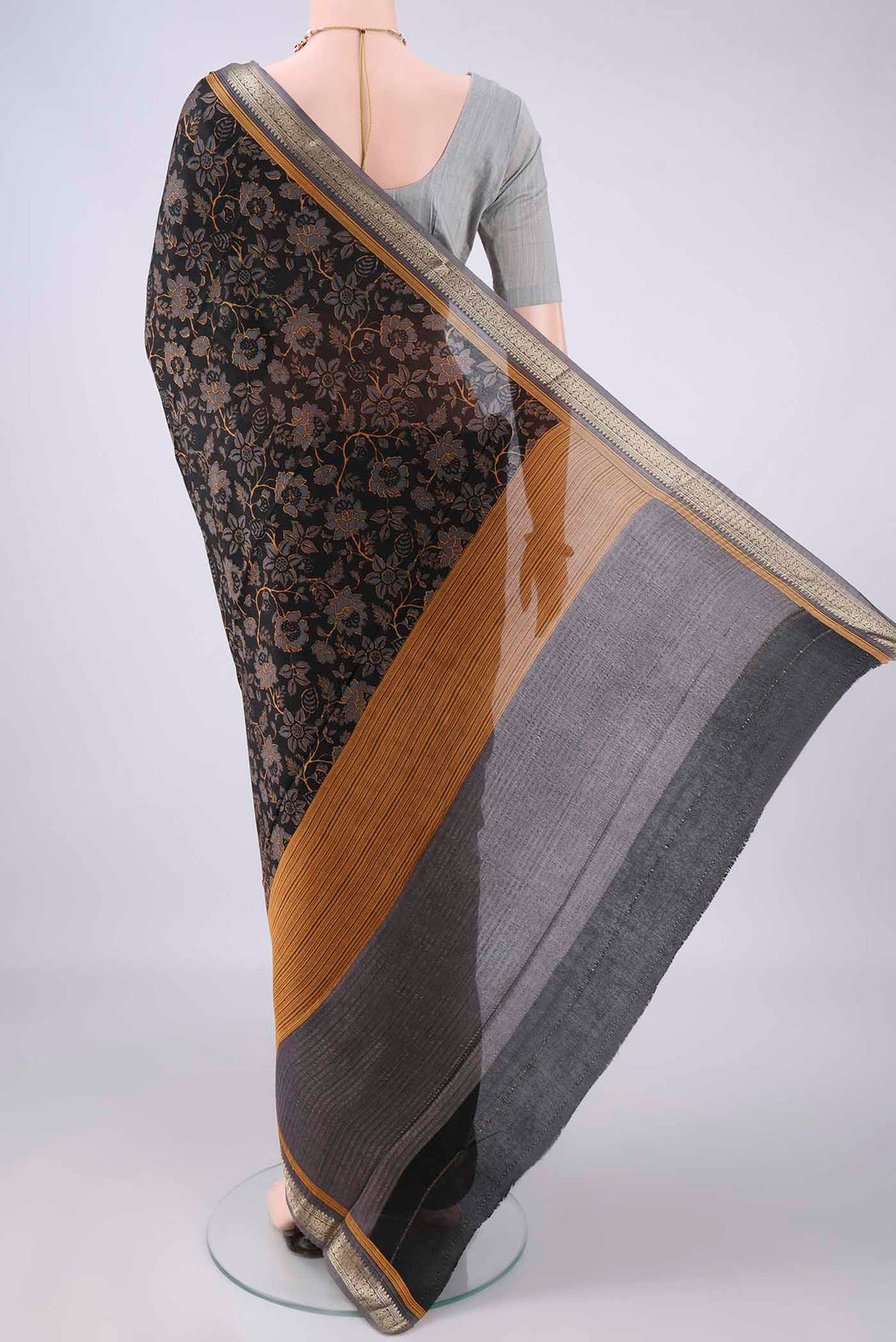 Flat view of Black Mysore Crepe Saree with Printed design on the body and Zari Border. 