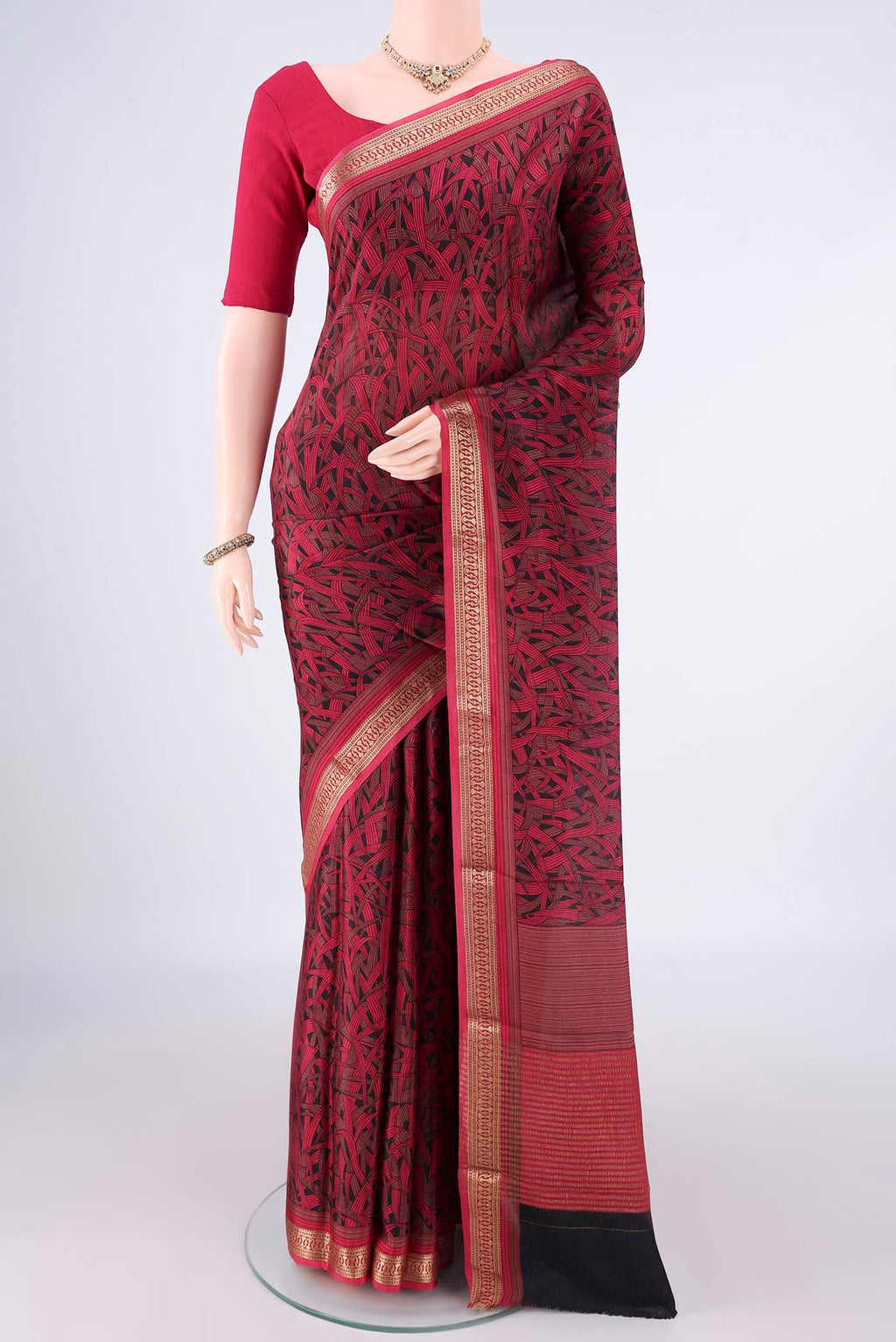 Black Mysore Crepe Saree with Printed design on the body and Zari Border.  displayed on a mannequin