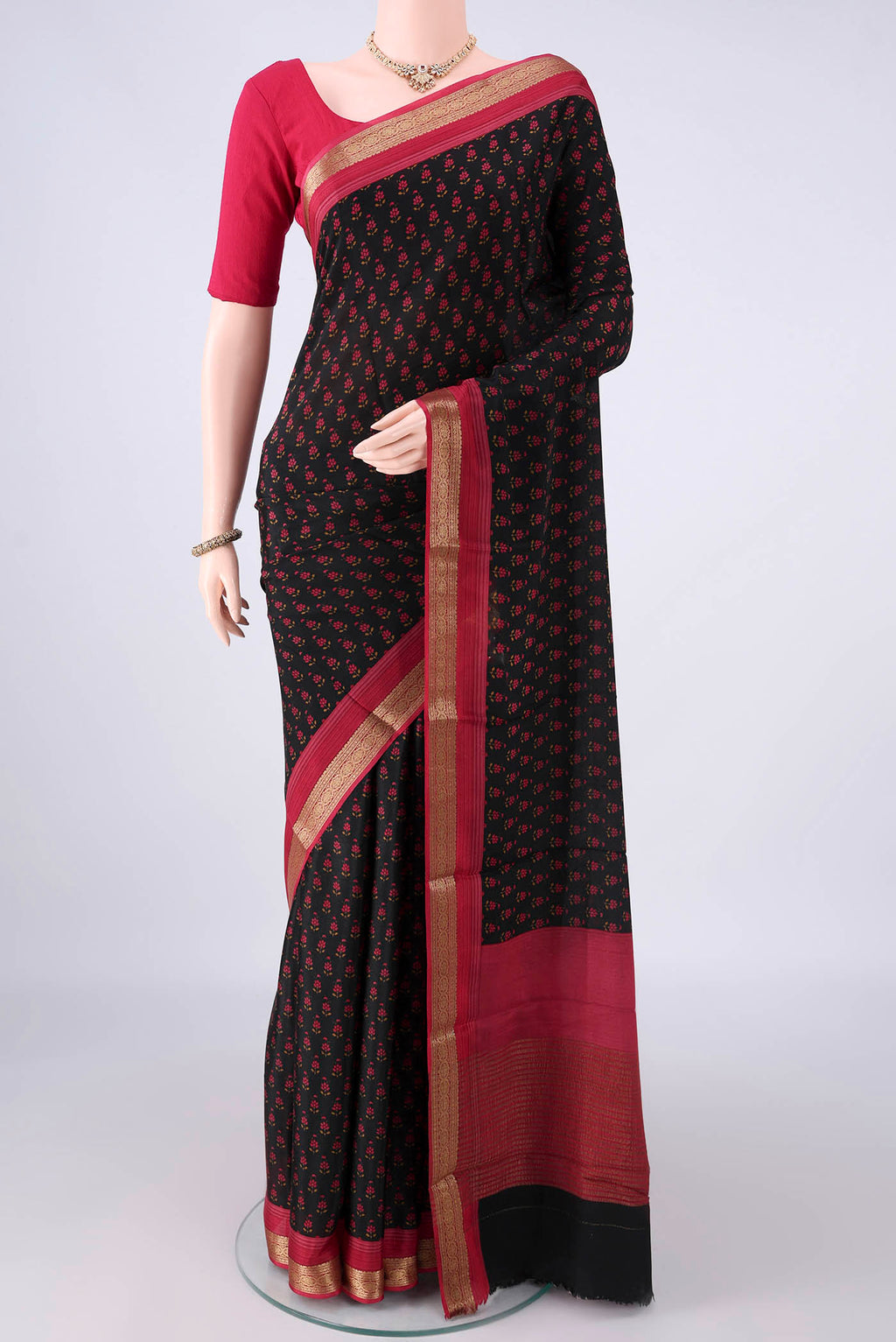 Black Mysore Crepe Saree with Printed design on the body and Zari Border.  displayed on a mannequin