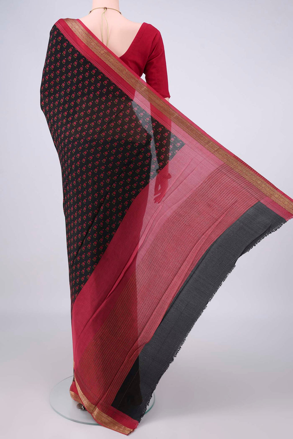Flat view of Black Mysore Crepe Saree with Printed design on the body and Zari Border. 