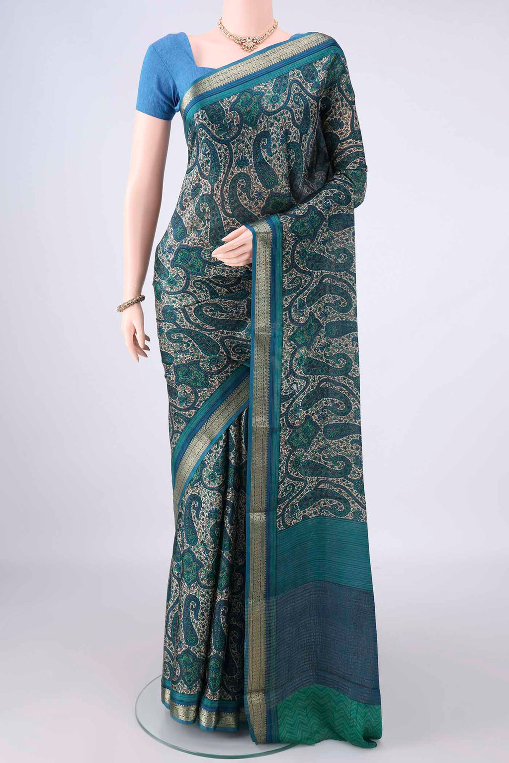 Sea Green Mysore Crepe Saree with Printed design on the body and Zari Border.  displayed on a mannequin