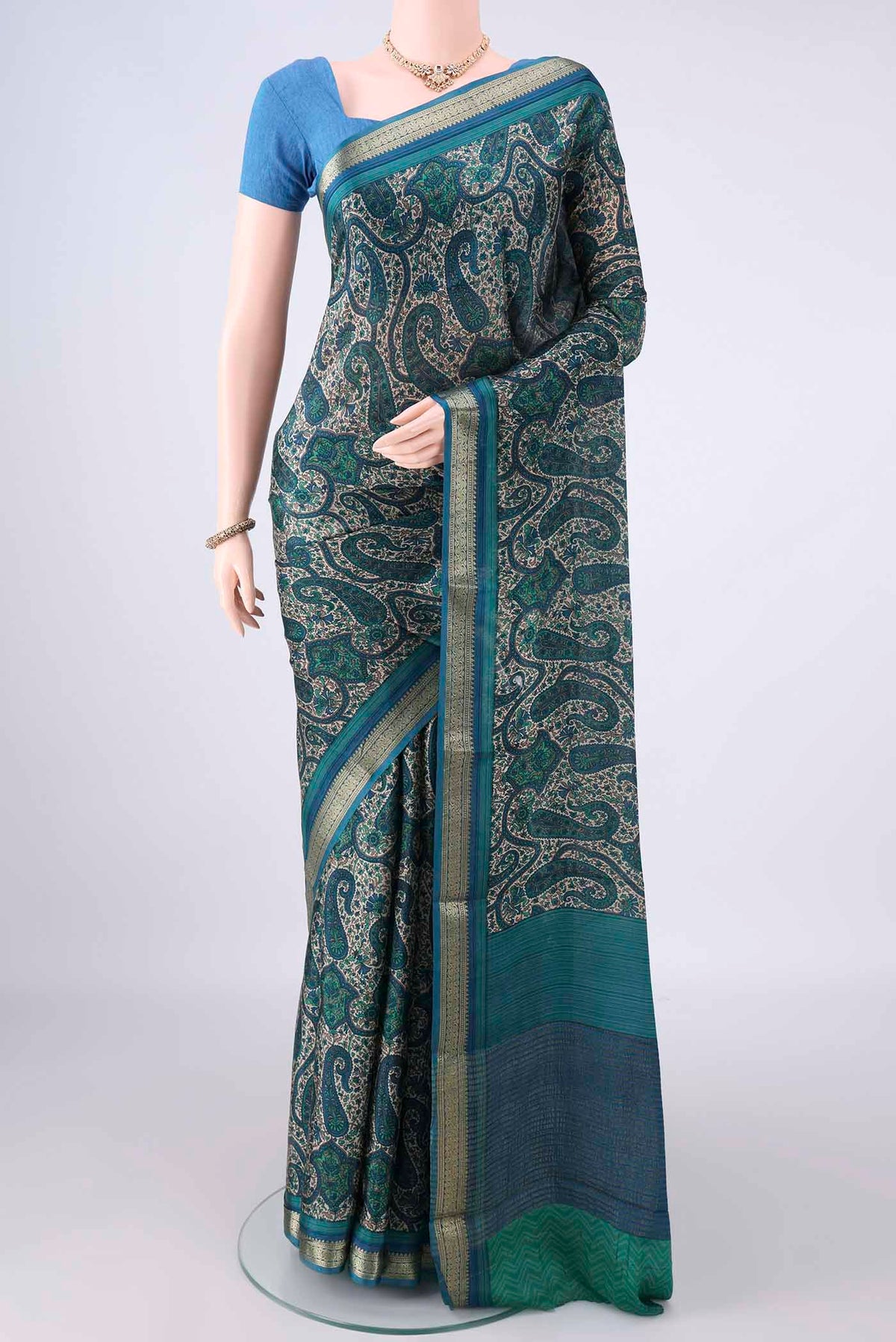 Sea Green Mysore Crepe Saree with Printed design on the body and Zari Border.  displayed on a mannequin