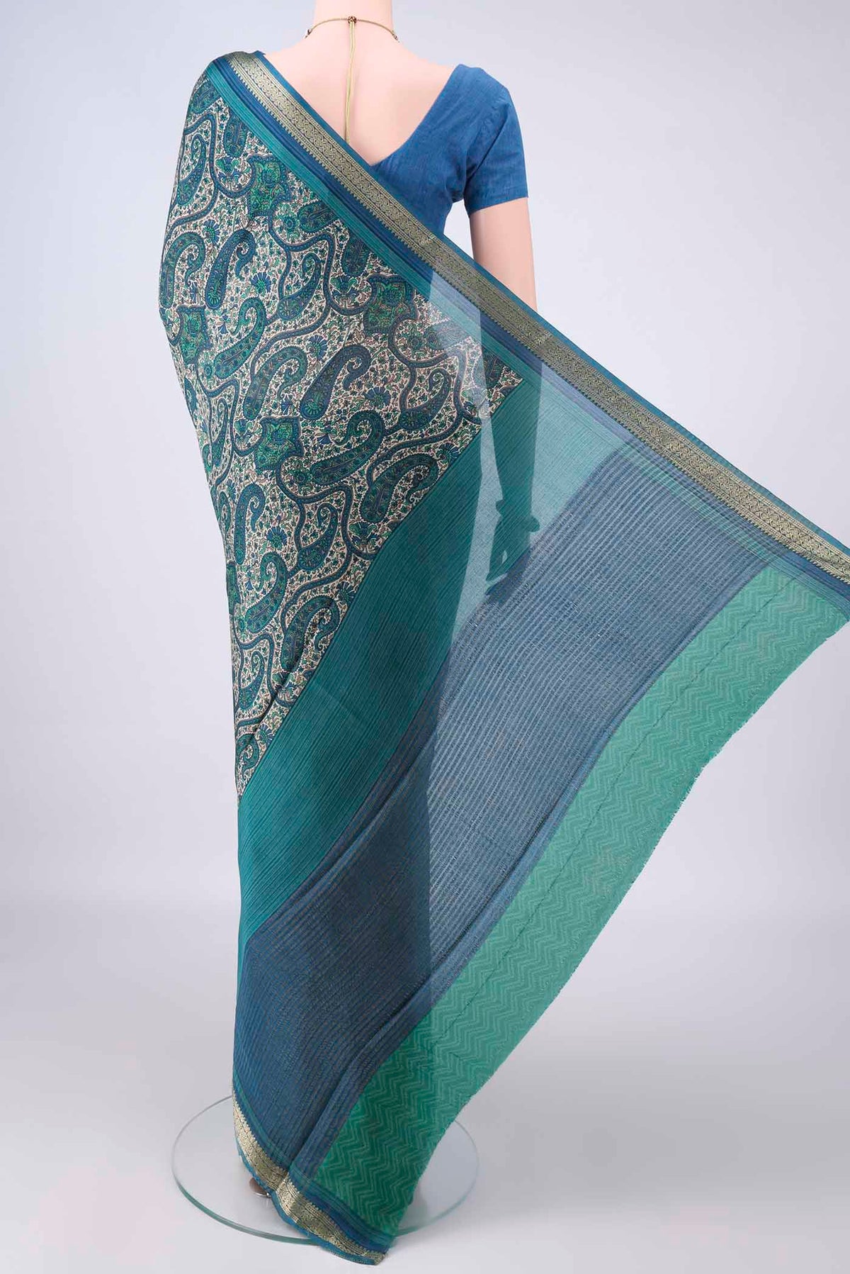 Flat view of Sea Green Mysore Crepe Saree with Printed design on the body and Zari Border. 