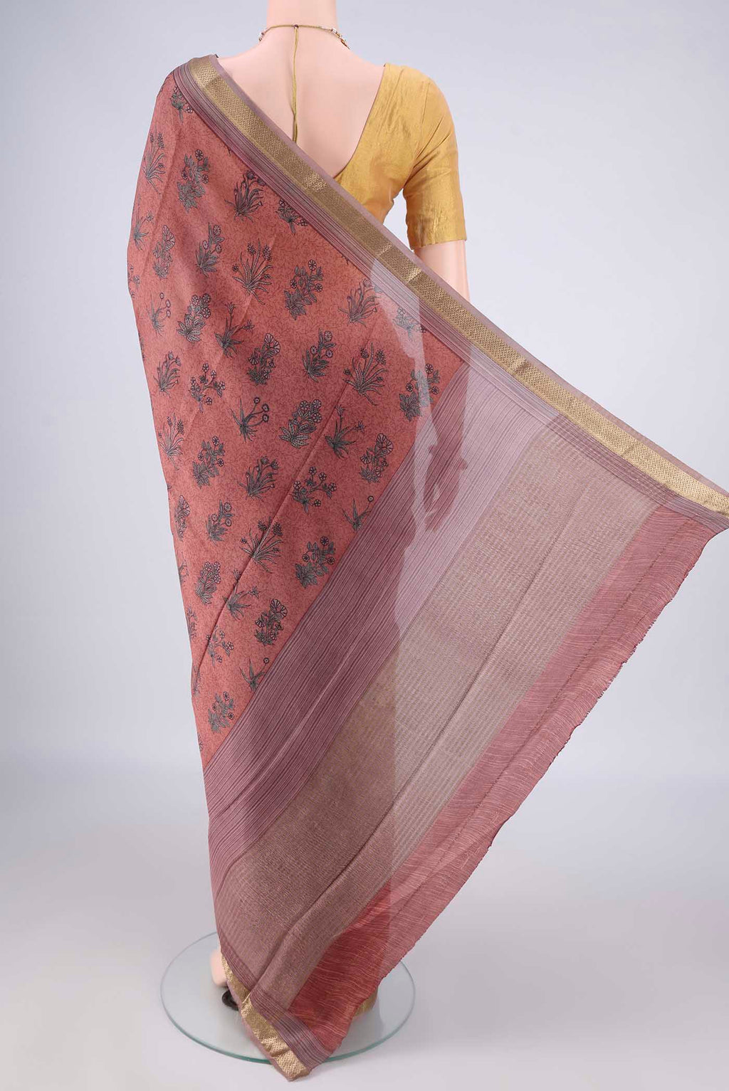 Flat view of Peach Mysore Crepe Saree with Printed design on the body and Zari Border. 