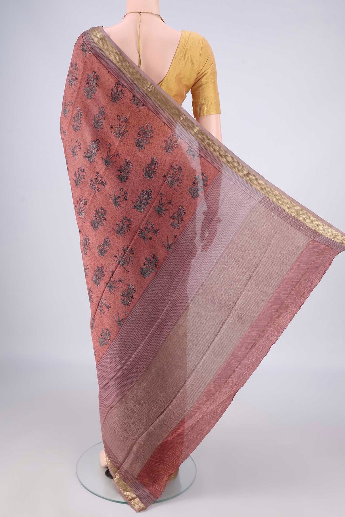 Flat view of Peach Mysore Crepe Saree with Printed design on the body and Zari Border. 