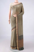 Beige Mysore Crepe Saree with Printed design on the body and Zari Border.  displayed on a mannequin