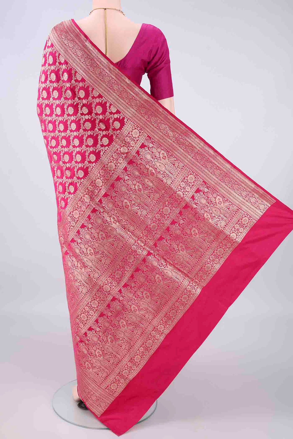 Flat view of Pure Silk Rani Pink Banarasi Saree with Zari Brocade on the body and Zari Border. 