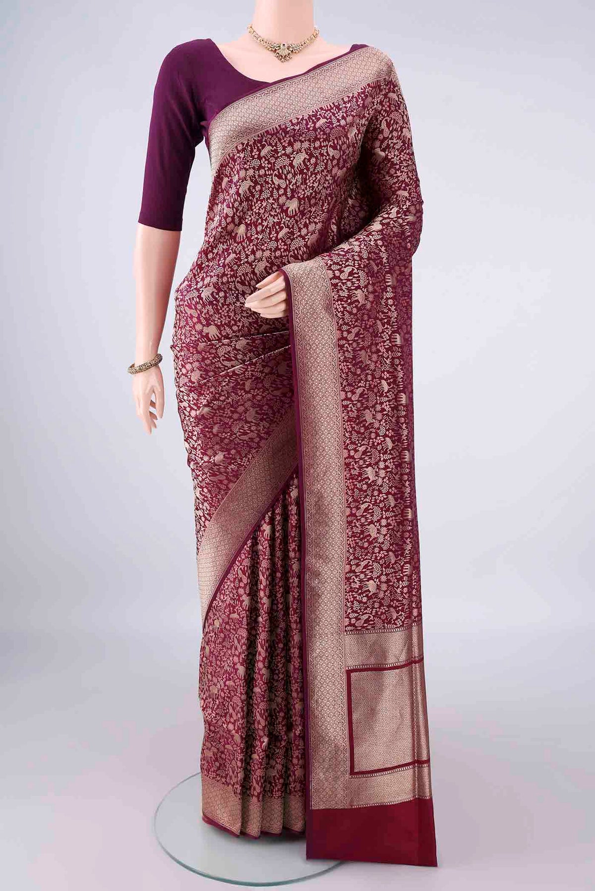 Pure Silk Burgundy Banarasi Saree with Zari Brocade on the body and Zari Border.  displayed on a mannequin