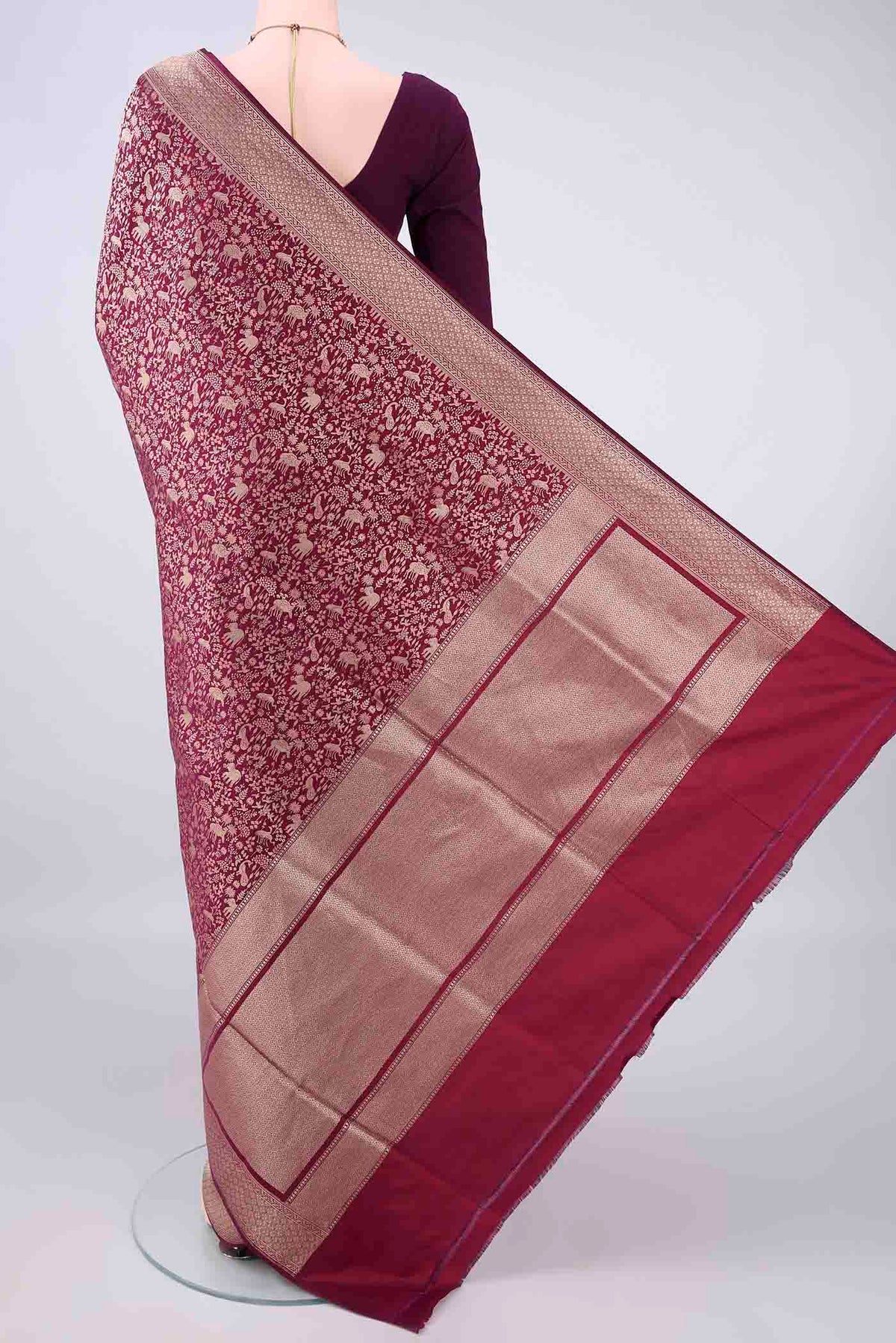 Flat view of Pure Silk Burgundy Banarasi Saree with Zari Brocade on the body and Zari Border. 