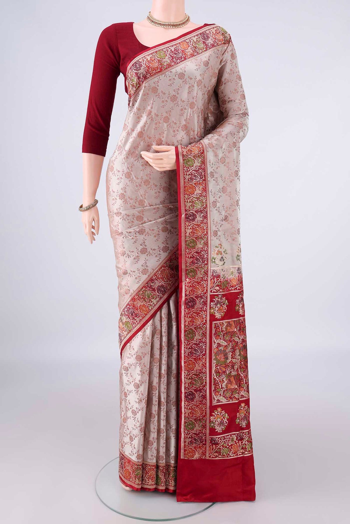 Beige Banarasi Jamavar Saree with Thread Brocade on the body and Zari Border.  displayed on a mannequin