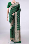 Pure Silk Bottle Green Banarasi Saree with Zari Butta on the body and Zari Border.  displayed on a mannequin