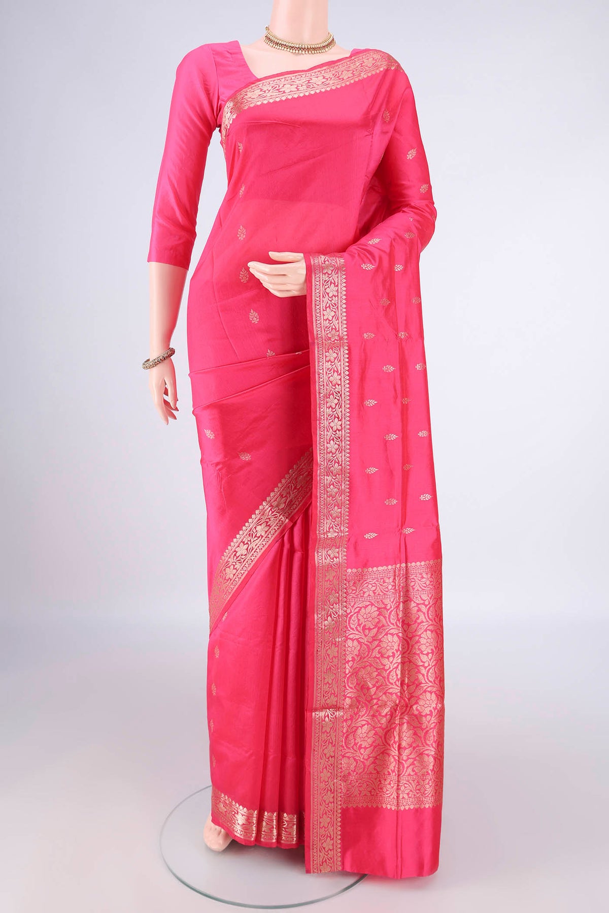 Pure Silk Coral Banarasi Katan Saree with Zari Butta on the body and Zari Border.  displayed on a mannequin