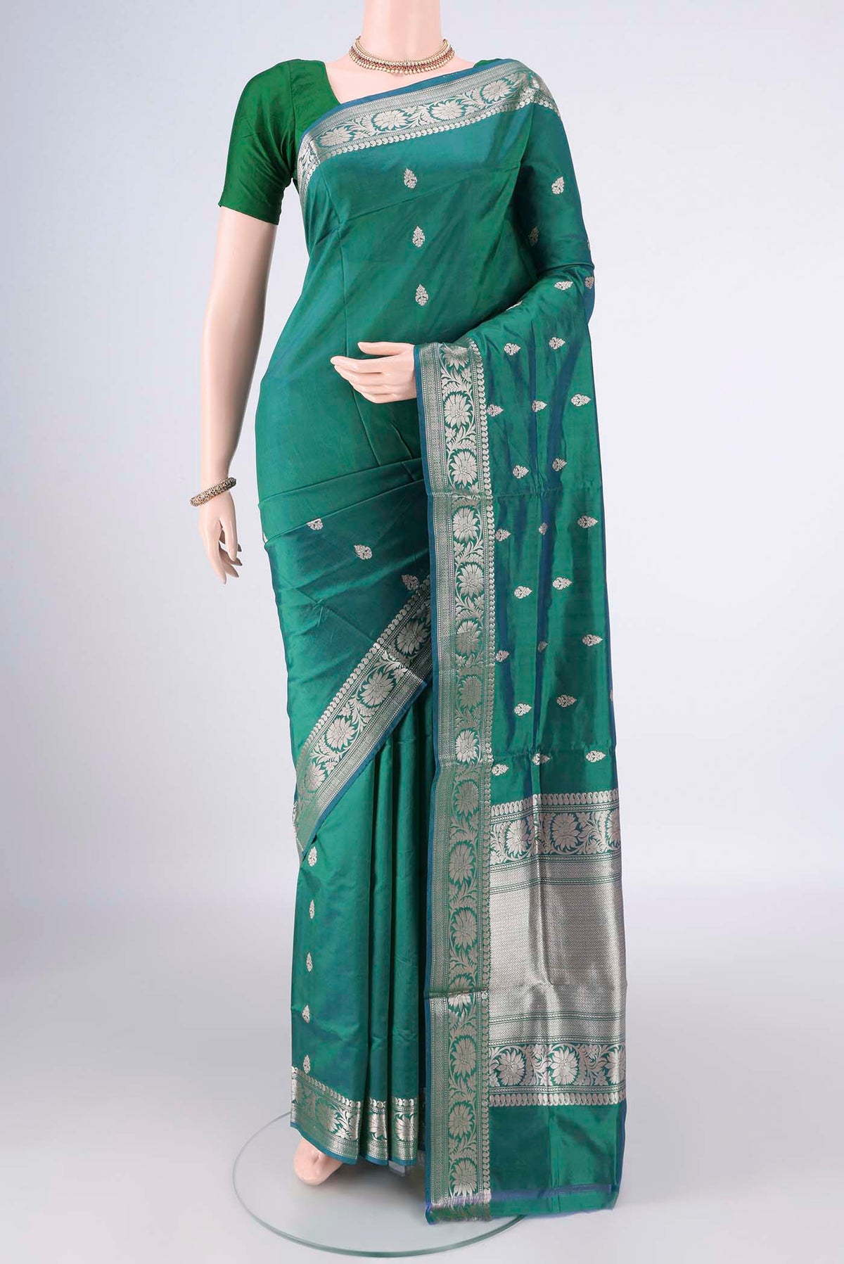 Pure Silk Green Dual Tone Banarasi Katan Saree with Zari Butta on the body and Zari Border.  displayed on a mannequin