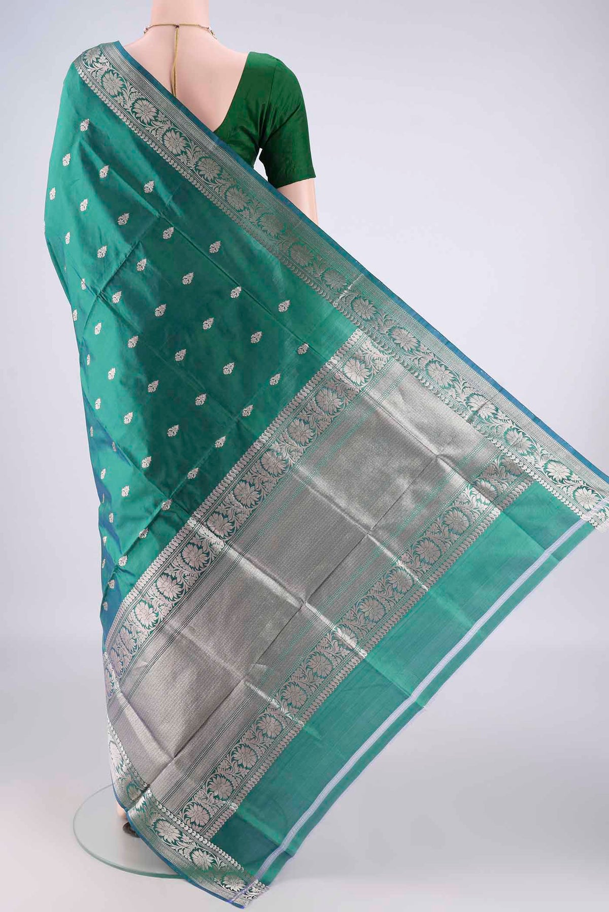 Flat view of Pure Silk Green Dual Tone Banarasi Katan Saree with Zari Butta on the body and Zari Border. 