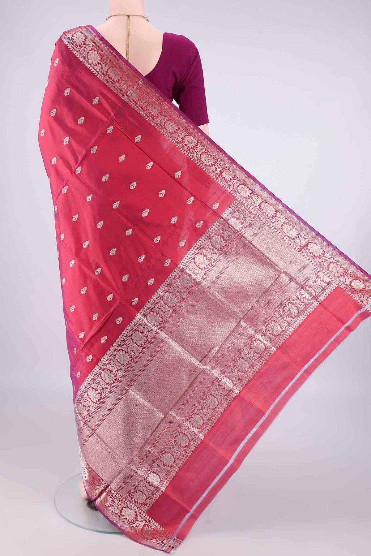 Flat view of Pure Silk Magenta Dual Tone Banarasi Katan Saree with Zari Butta on the body and Zari Border. 