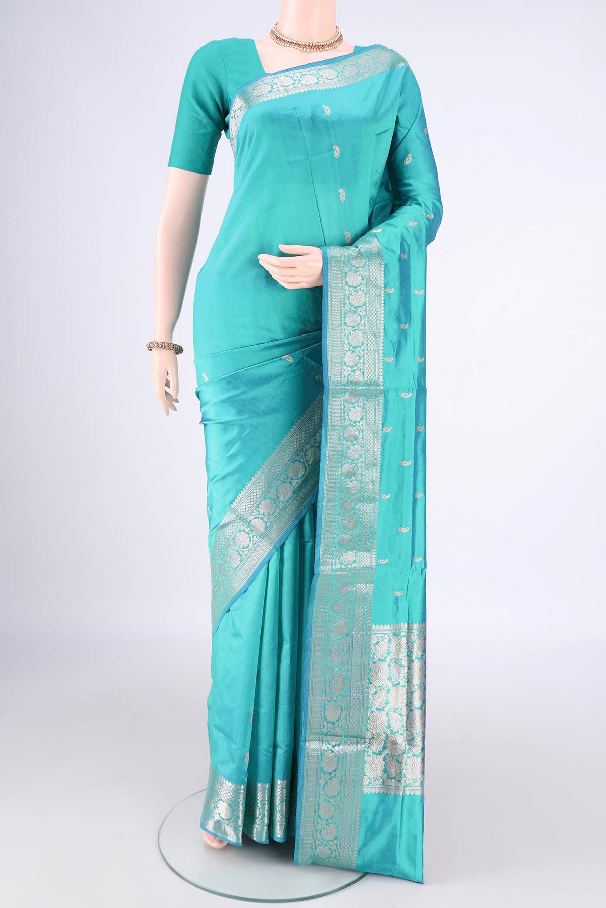 Pure Silk Turquoise Dual Tone Banarasi Katan Saree with Zari Butta on the body and Zari Border.  displayed on a mannequin