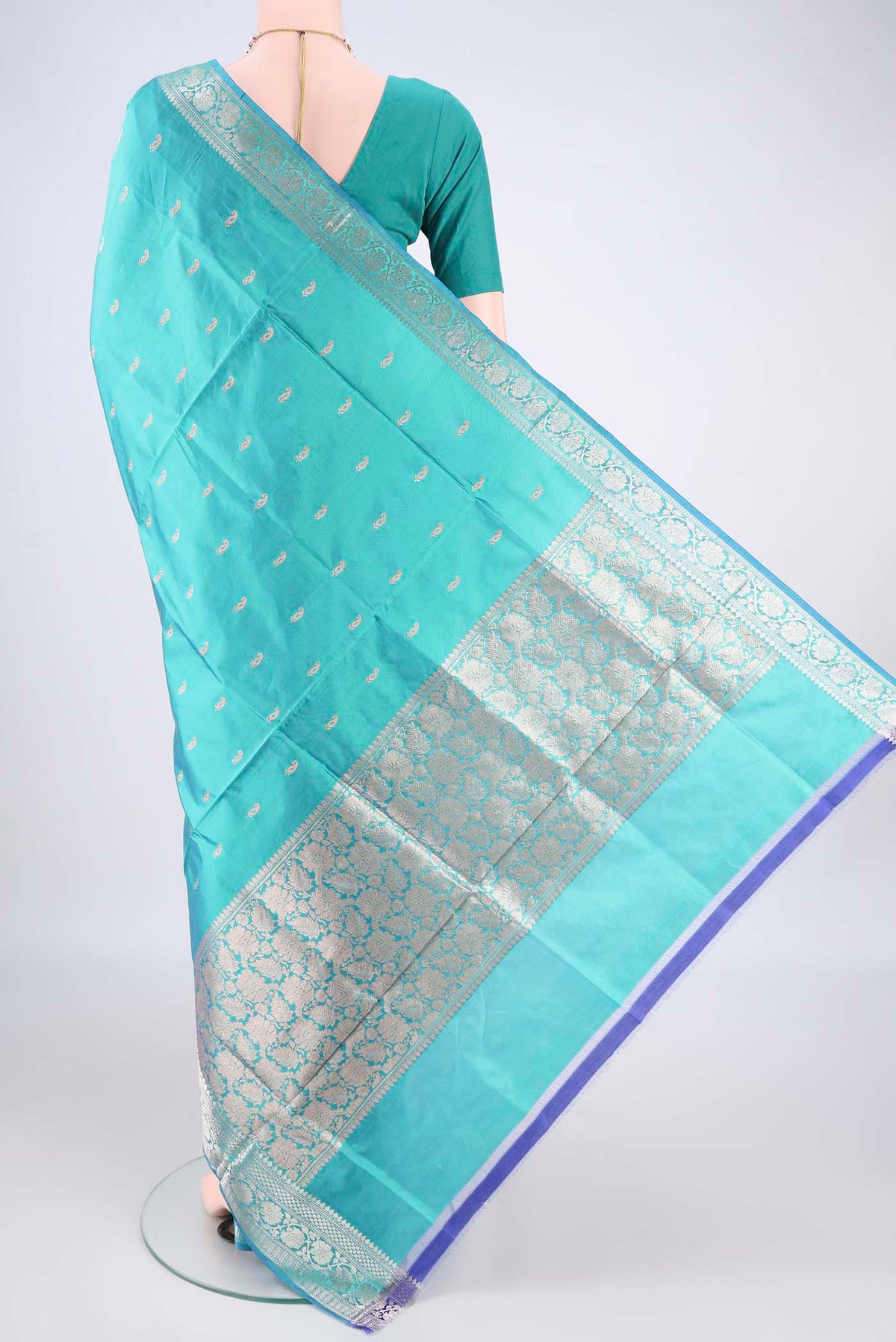 Flat view of Pure Silk Turquoise Dual Tone Banarasi Katan Saree with Zari Butta on the body and Zari Border. 