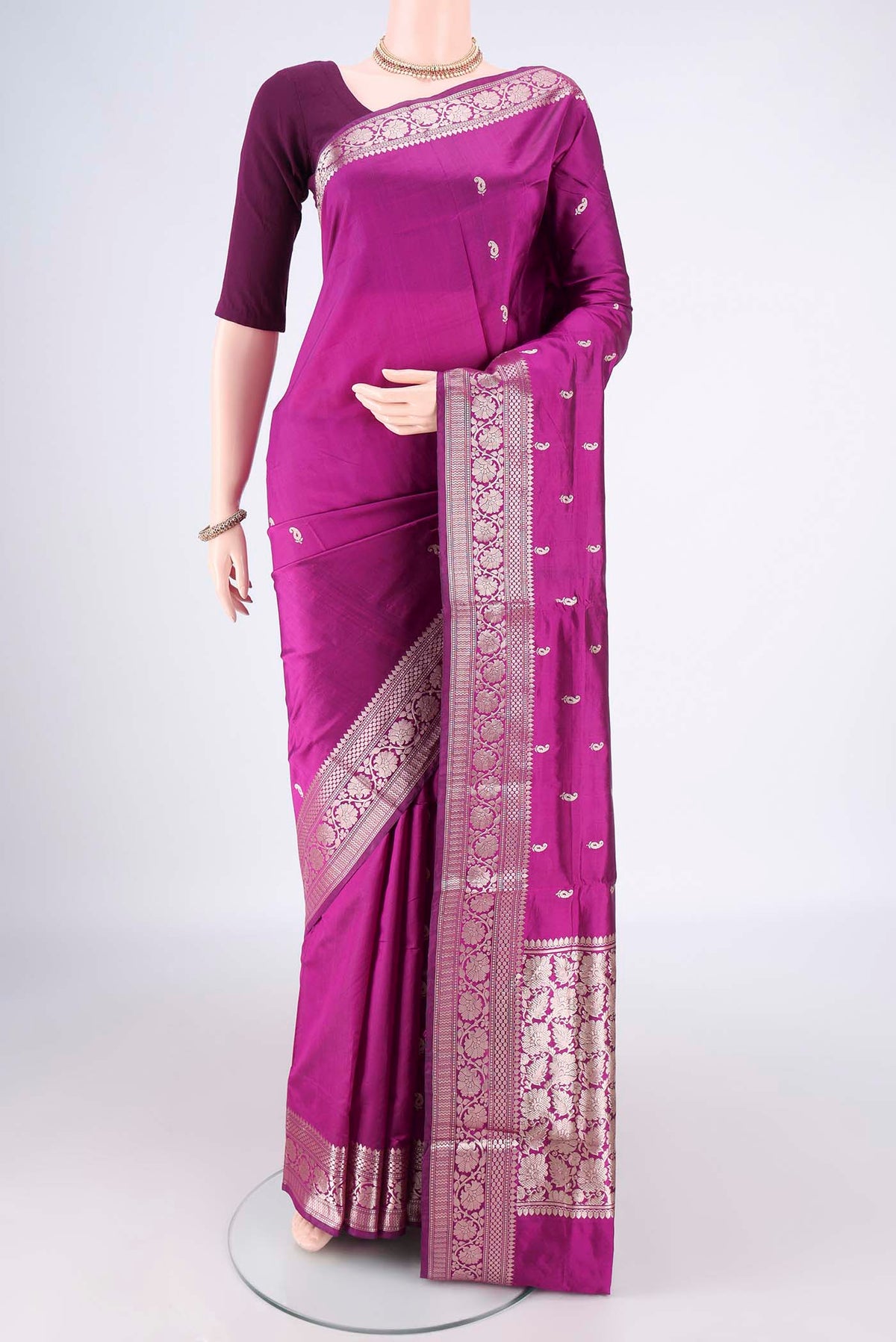 Pure Silk Magenta Banarasi Katan Saree with Zari Butta on the body and Zari Border.  displayed on a mannequin
