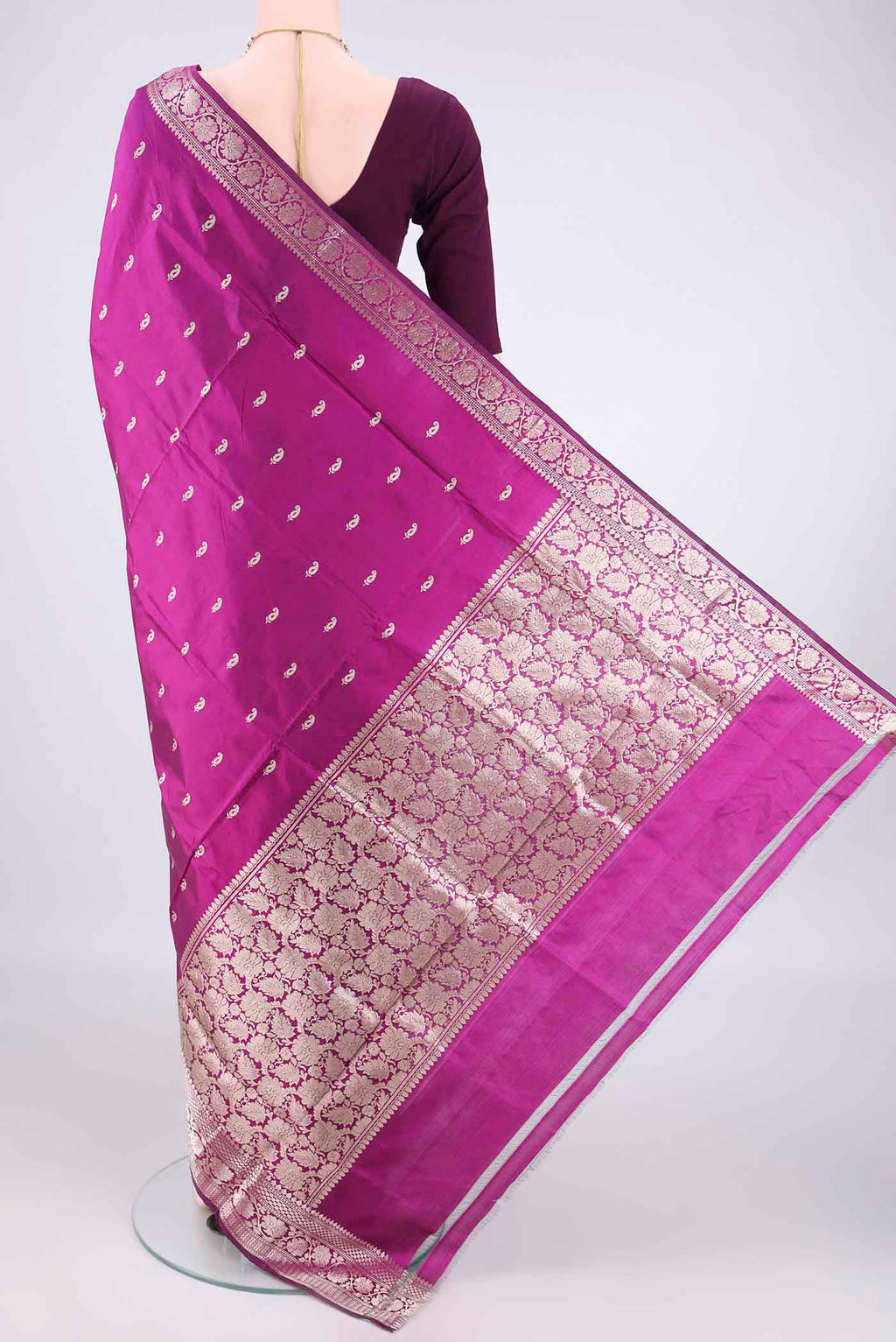Flat view of Pure Silk Magenta Banarasi Katan Saree with Zari Butta on the body and Zari Border. 