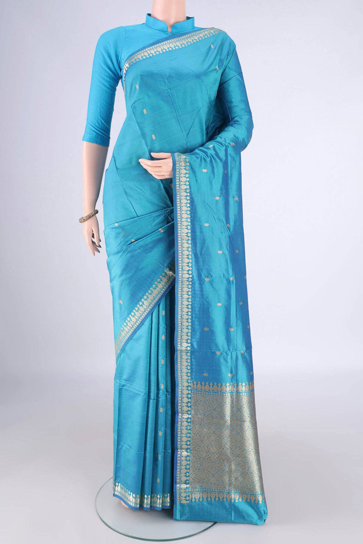 Pure Silk Sky Blue Banarasi Katan Saree with Thread Butta on the body and Zari Border.  displayed on a mannequin