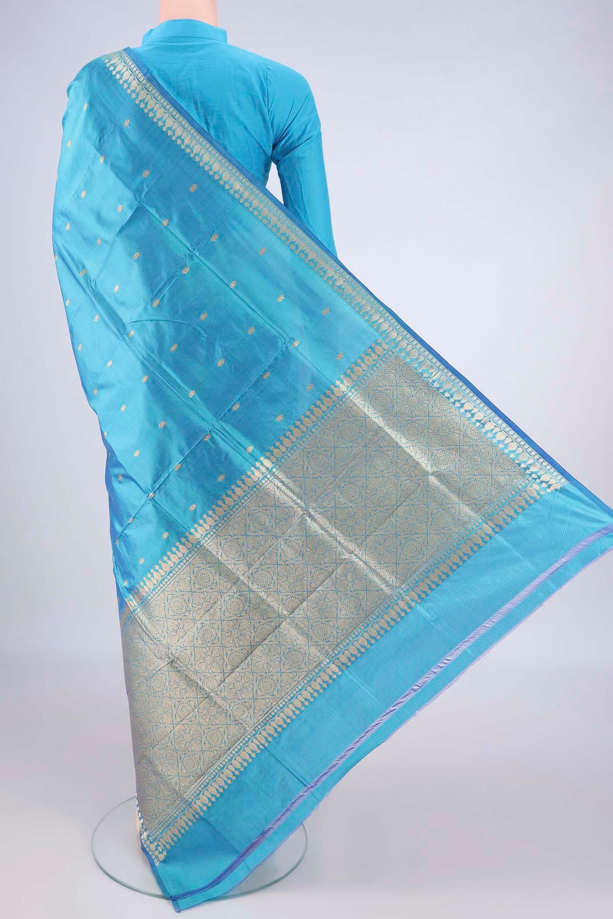 Flat view of Pure Silk Sky Blue Banarasi Katan Saree with Thread Butta on the body and Zari Border. 