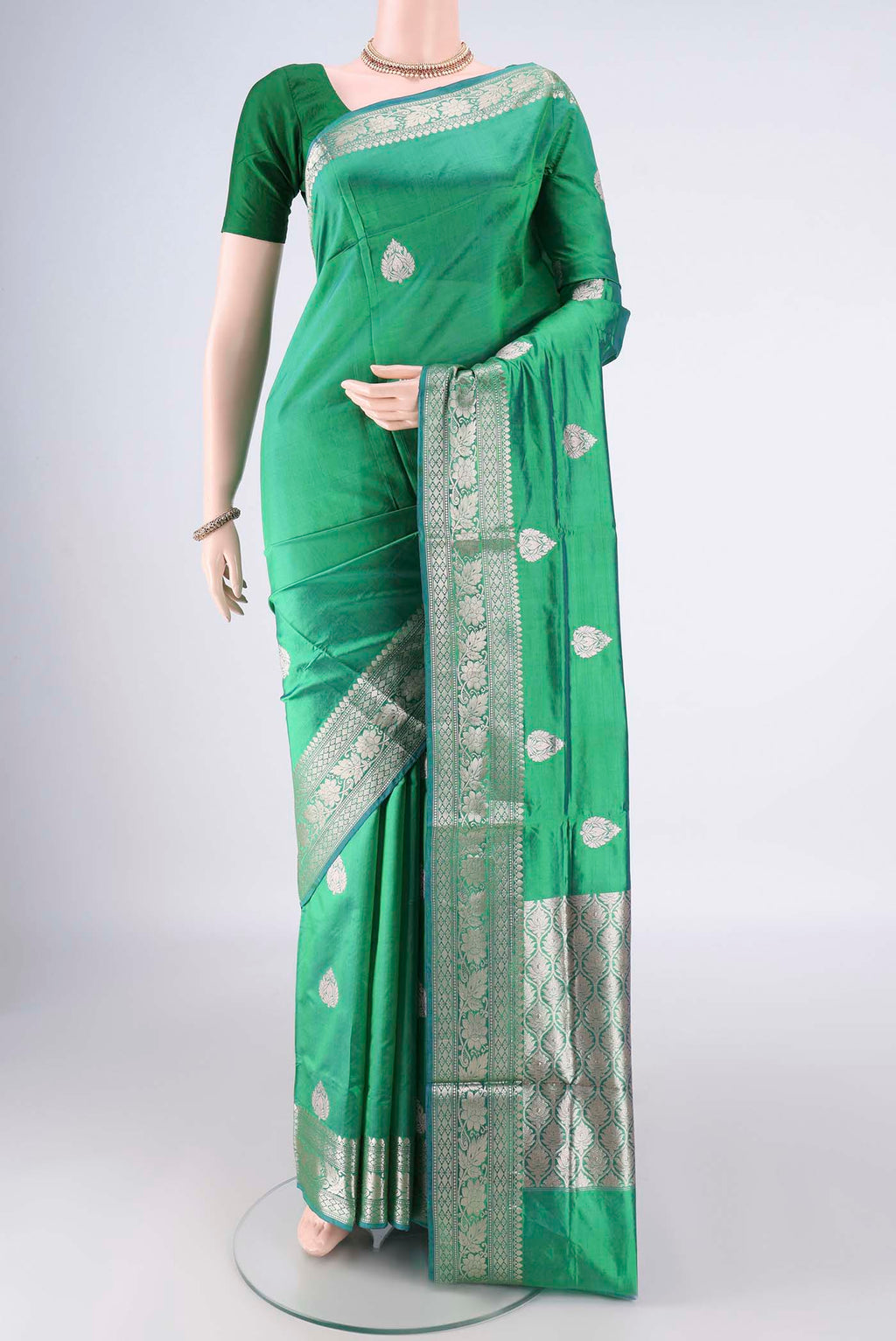 Pure Silk Green Dual Tone Banarasi Katan Saree with Zari Butta on the body and Zari Border.  displayed on a mannequin