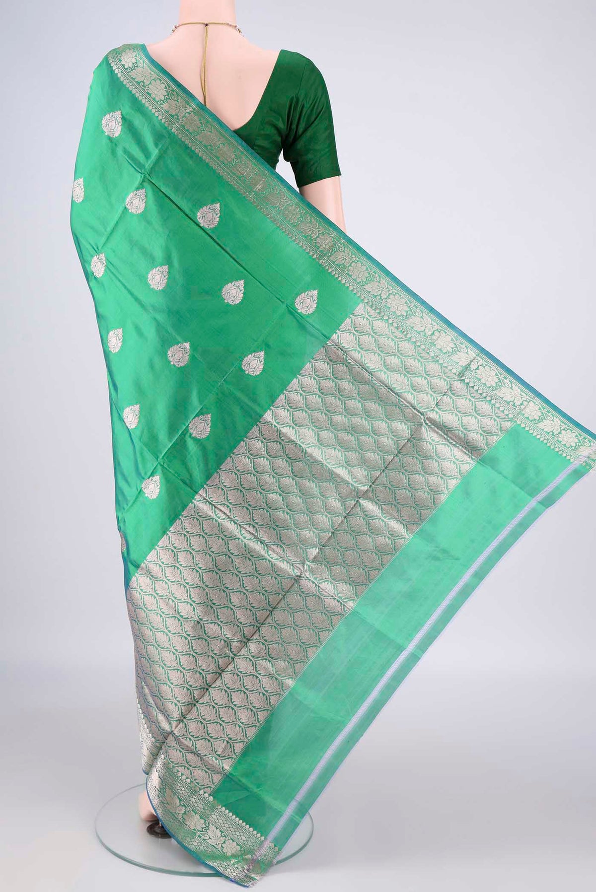 Flat view of Pure Silk Green Dual Tone Banarasi Katan Saree with Zari Butta on the body and Zari Border. 