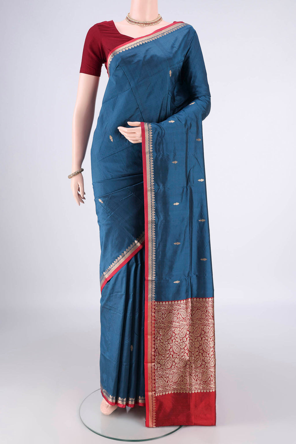 Pure Silk Blue Banarasi Katan Saree with Zari Butta on the body and Zari Border.  displayed on a mannequin