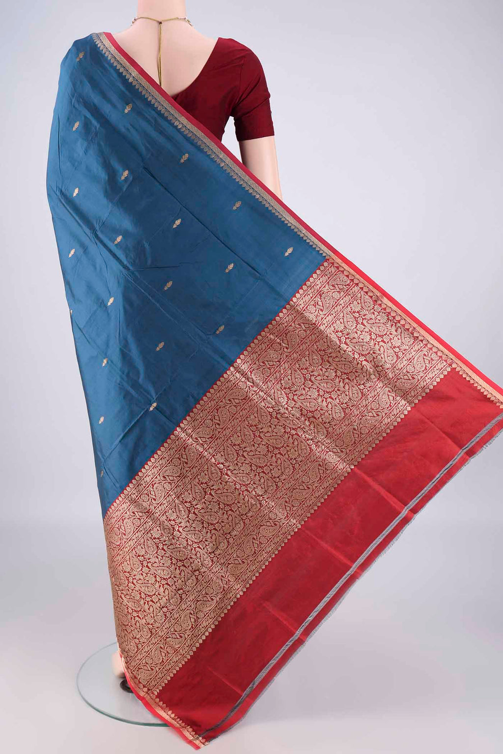 Flat view of Pure Silk Blue Banarasi Katan Saree with Zari Butta on the body and Zari Border. 