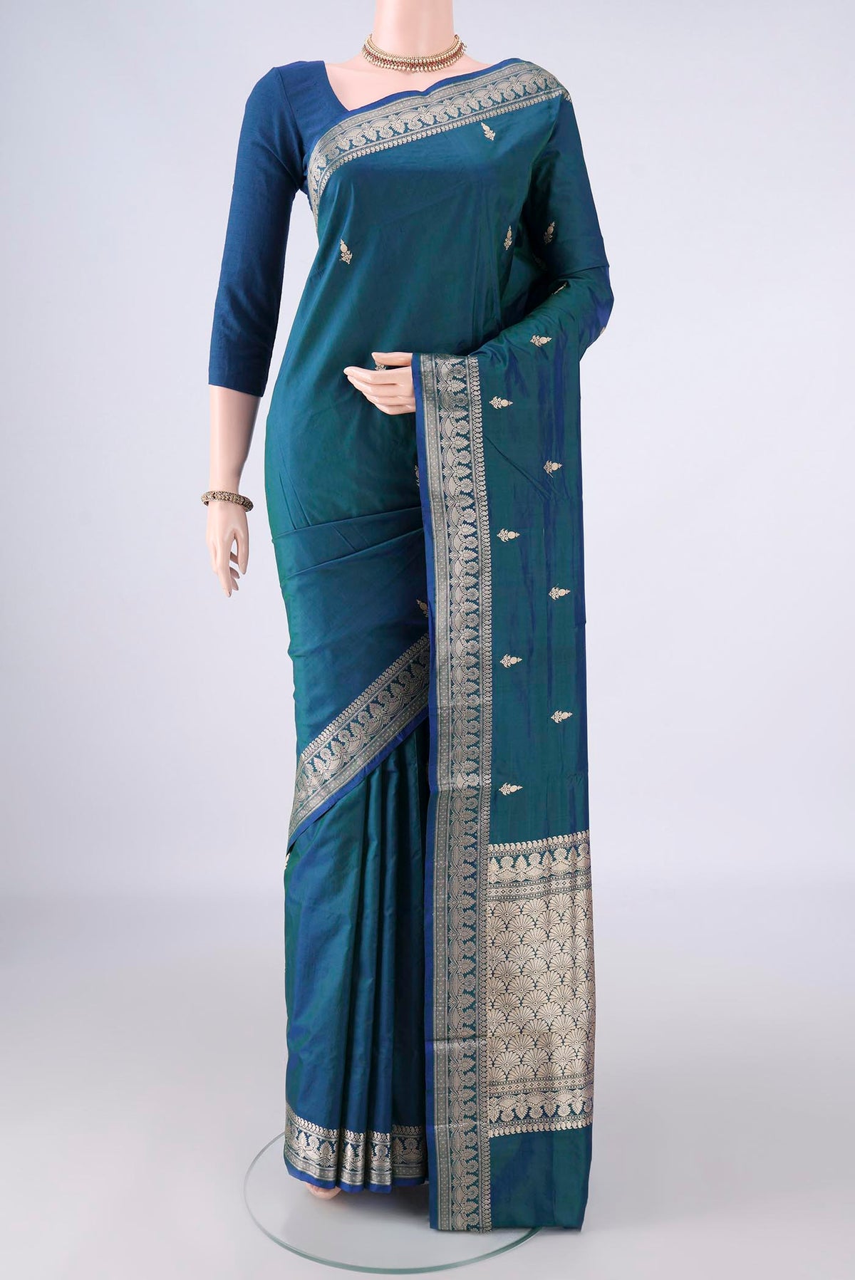 Pure Silk Peacock Blue Banarasi Katan Saree with Thread Butta on the body and Thread Border.  displayed on a mannequin