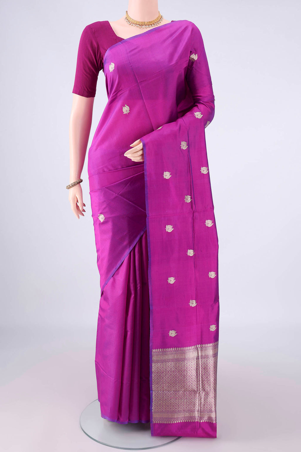 Pure Silk Magenta Banarasi Katan Saree with Zari Butta on the body and Without Border.  displayed on a mannequin