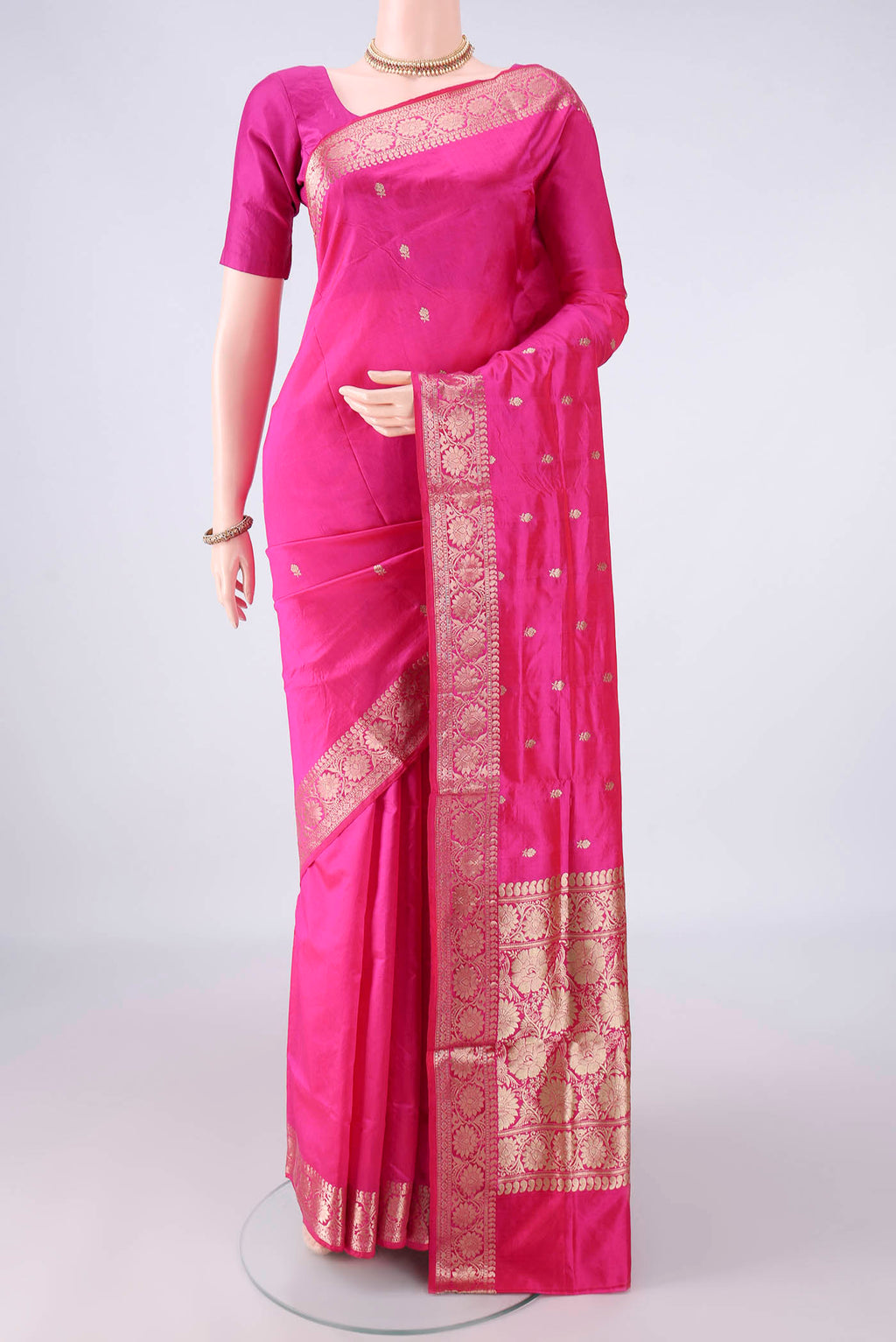 Pure Silk Pink Banarasi Katan Saree with Zari Butta on the body and Zari Border.  displayed on a mannequin