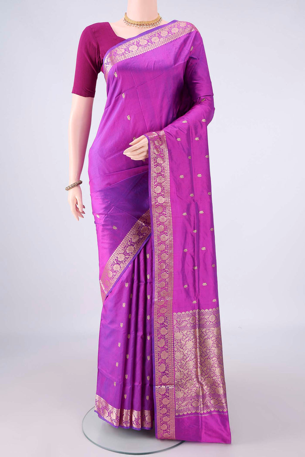 Pure Silk Magenta Banarasi Katan Saree with Zari Butta on the body and Zari Border.  displayed on a mannequin