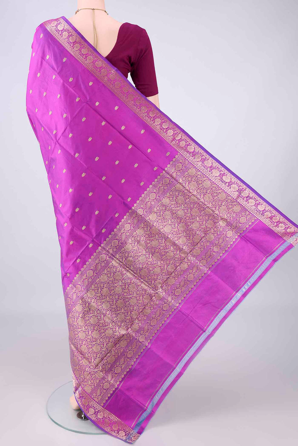 Flat view of Pure Silk Magenta Banarasi Katan Saree with Zari Butta on the body and Zari Border. 