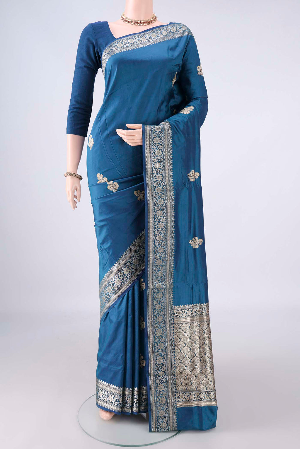 Pure Silk Blue Banarasi Katan Saree with Thread Butta on the body and Thread Border.  displayed on a mannequin