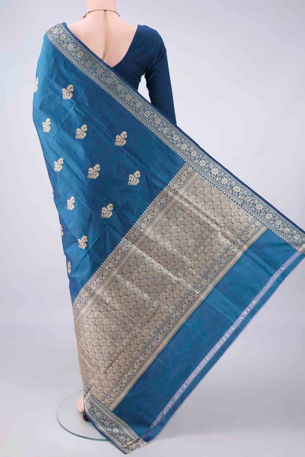 Flat view of Pure Silk Blue Banarasi Katan Saree with Thread Butta on the body and Thread Border. 