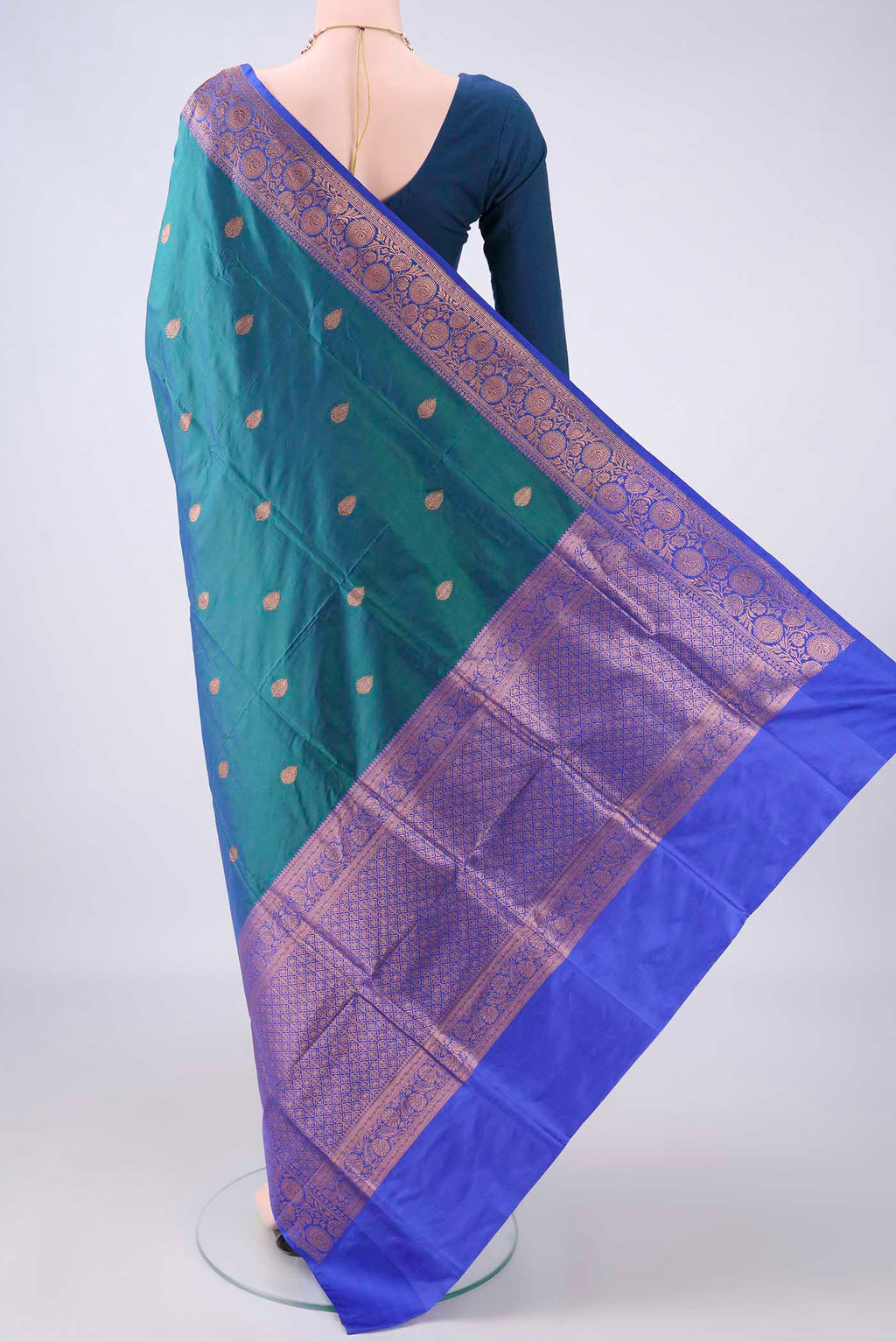 Flat view of Pure Silk Peacock Blue Dual Tone Banarasi Katan Saree with Zari Butta on the body and Zari Border. 