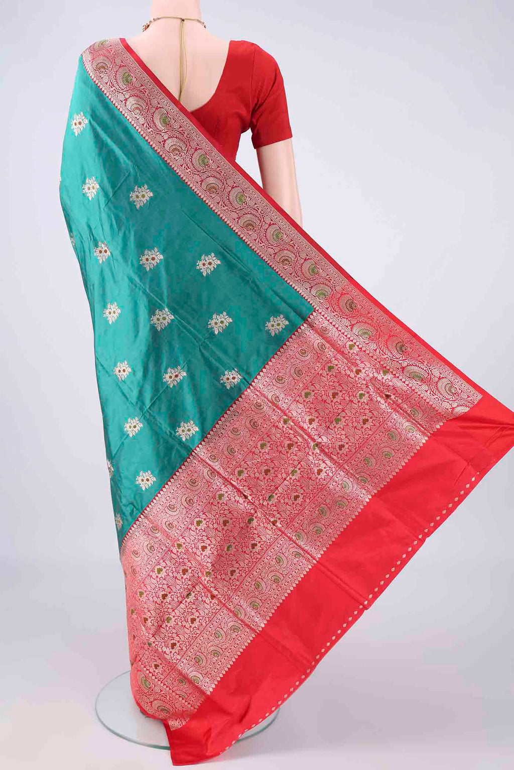 Flat view of Pure Silk Sea Green Banarasi Katan Saree with Zari And Thread Butta on the body and Zari Border. 