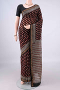 Black Chanderi Cotton Saree with Batik Print on the body and Thin Zari Line.  displayed on a mannequin